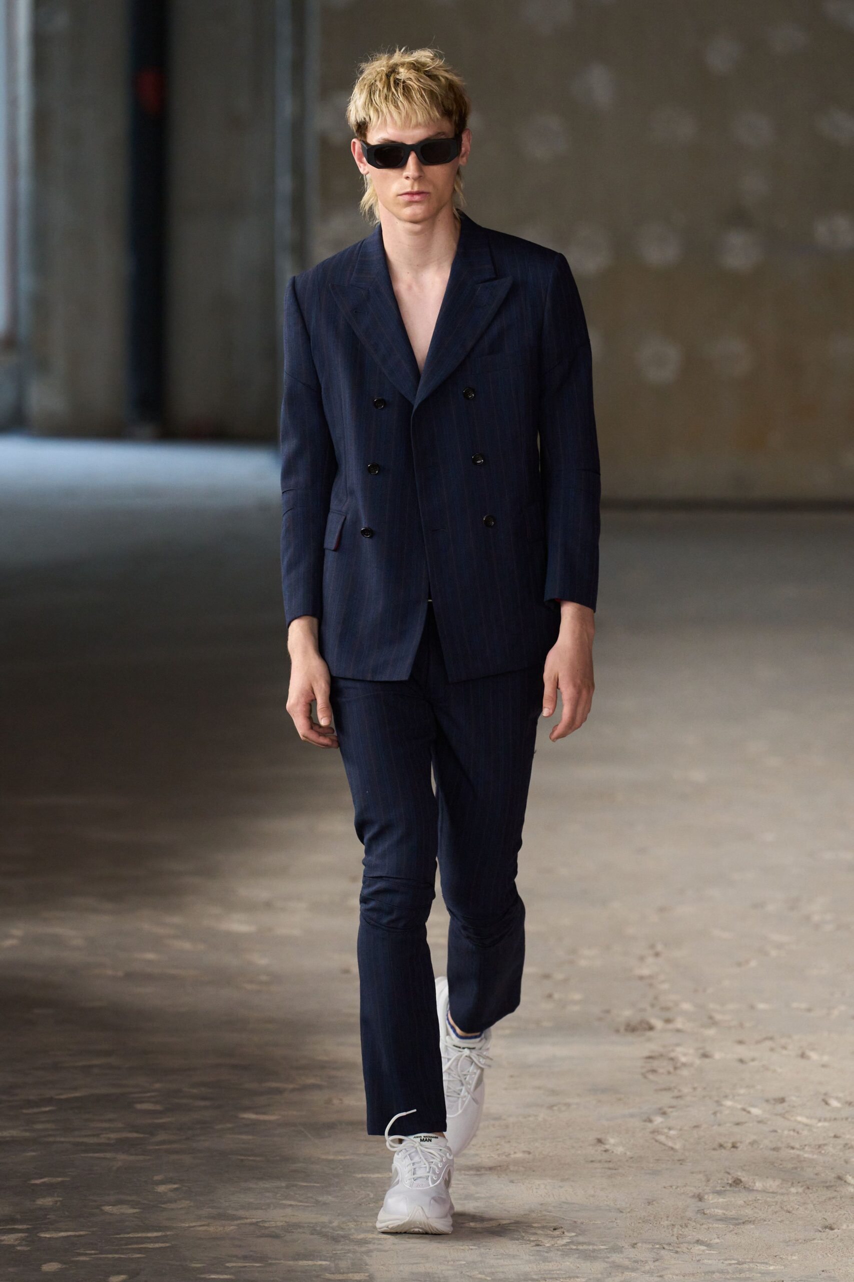 blue tailored suit with white shoes
