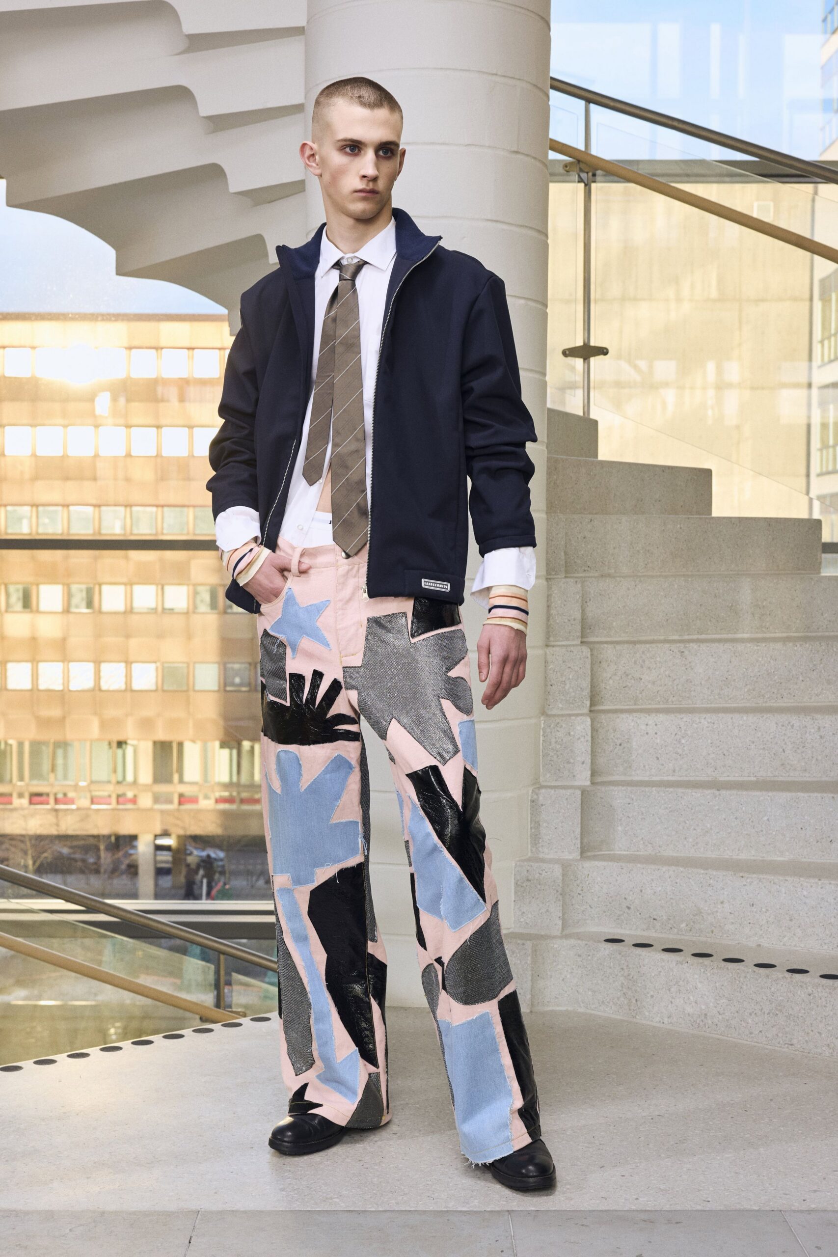 black jacket white shirt multi pants