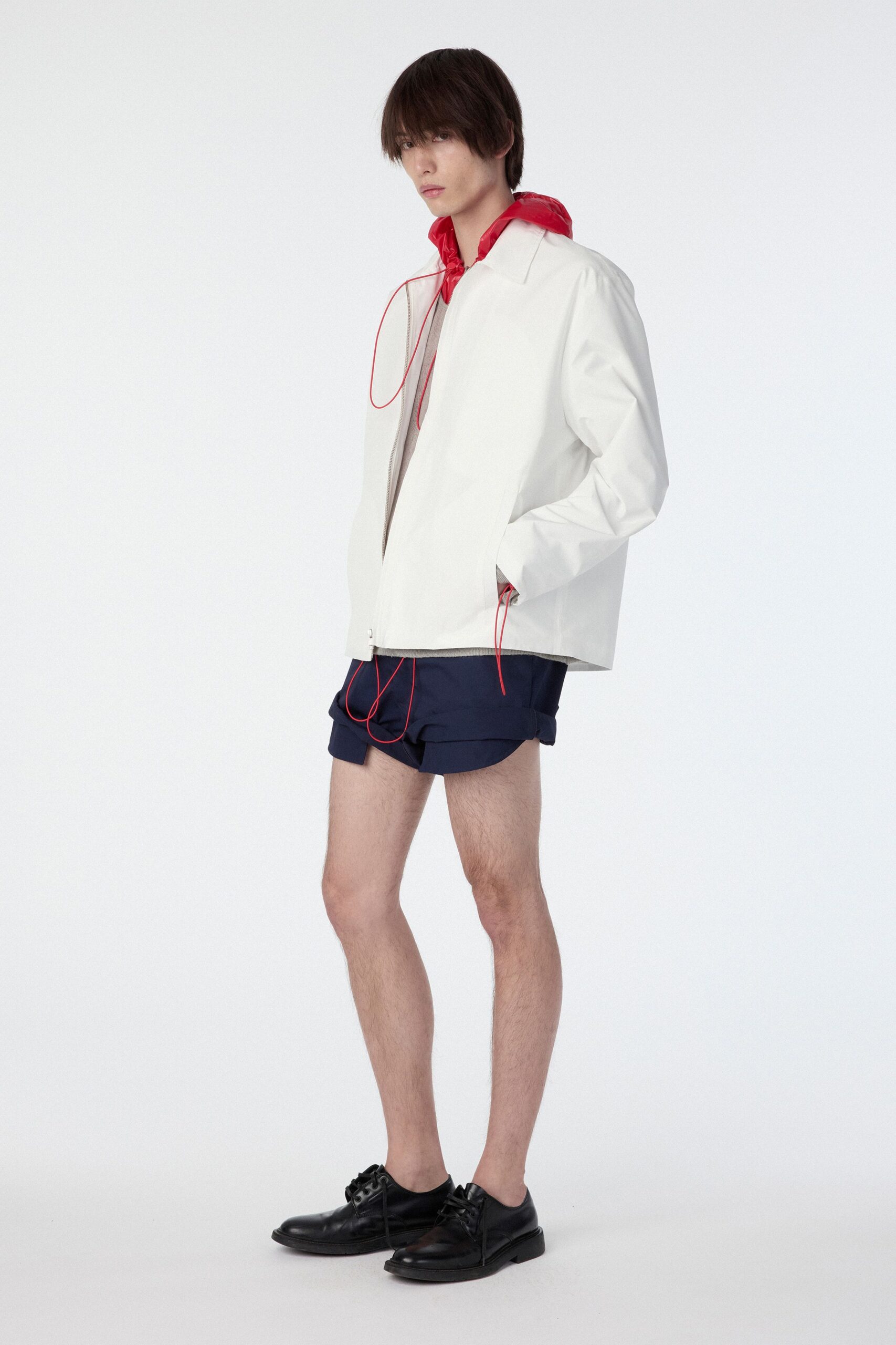 white relaxed jacket with navy shorts