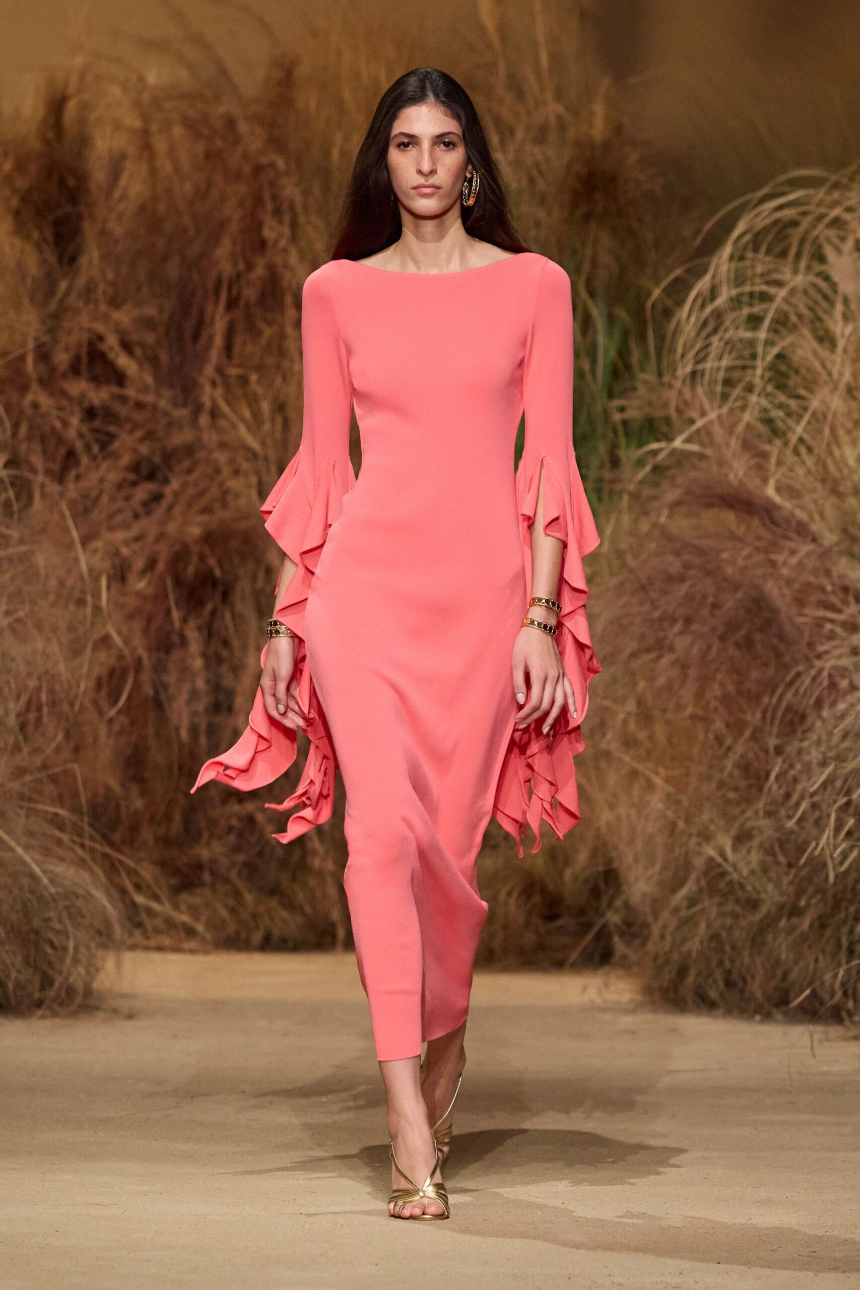 pink ruffled midi dress with gold shoes