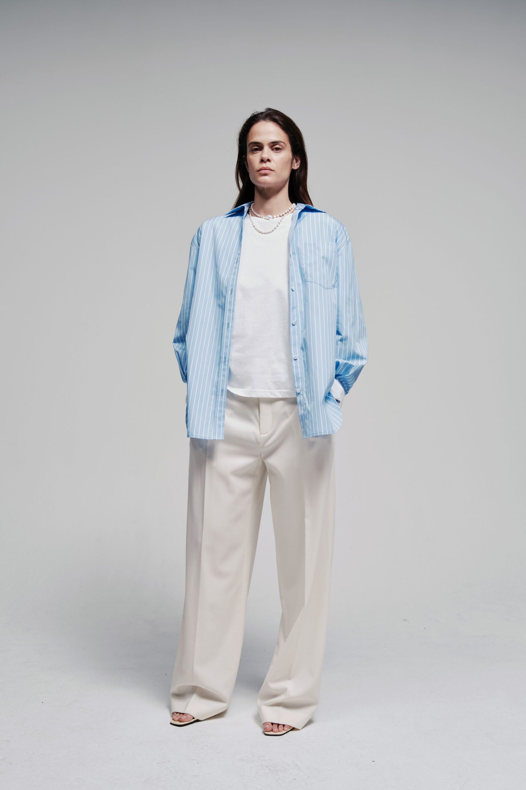 blue striped shirt with beige pants
