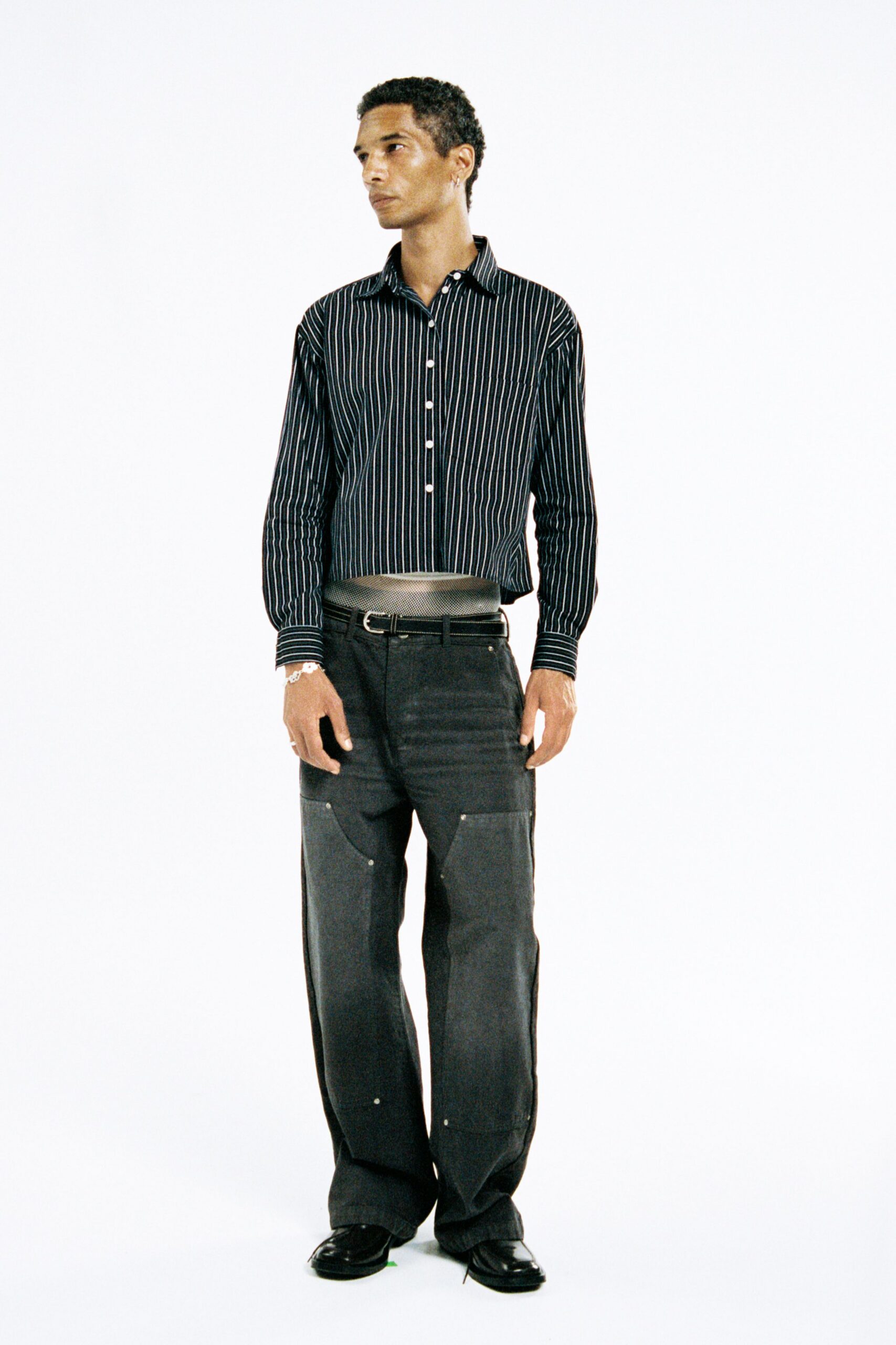 black and white striped shirt with gray pants