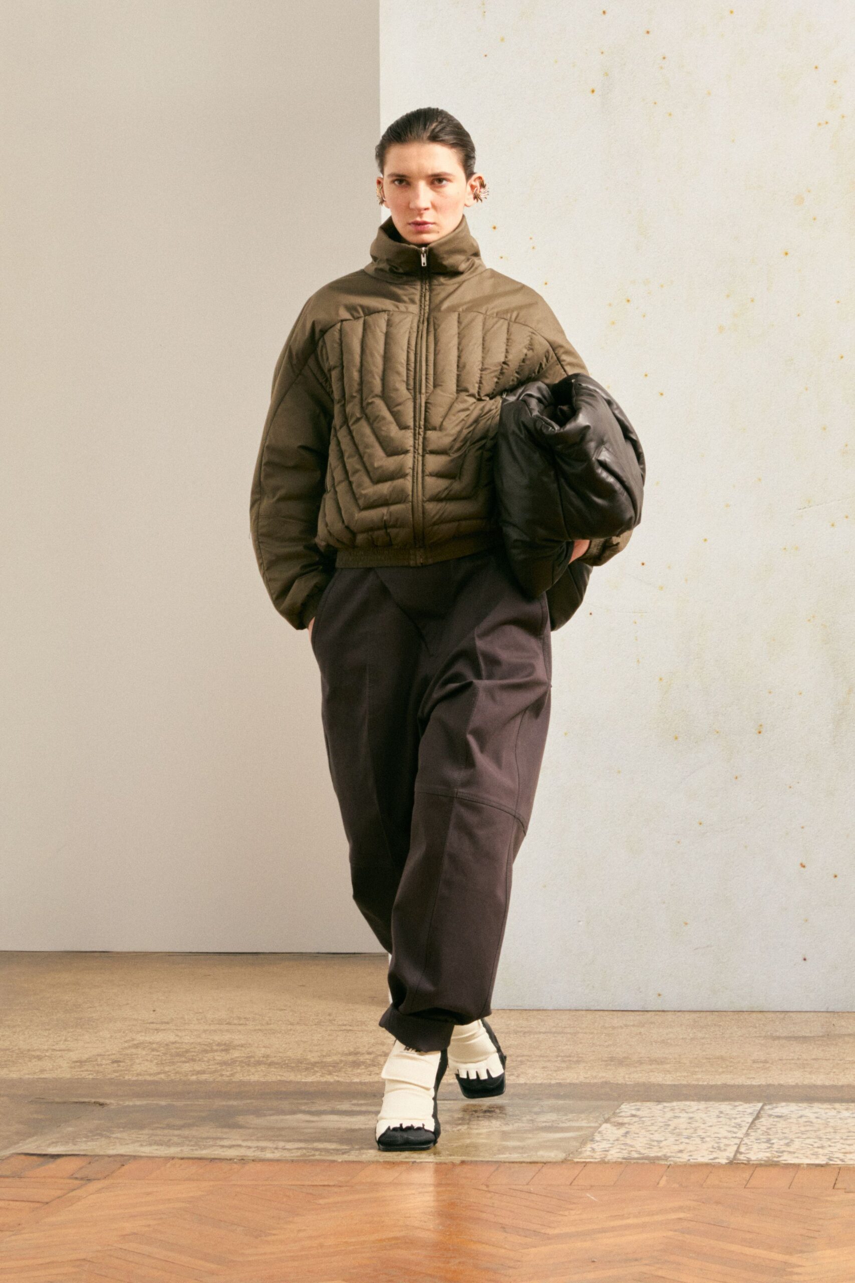 brown quilted jacket gray pants white shoes