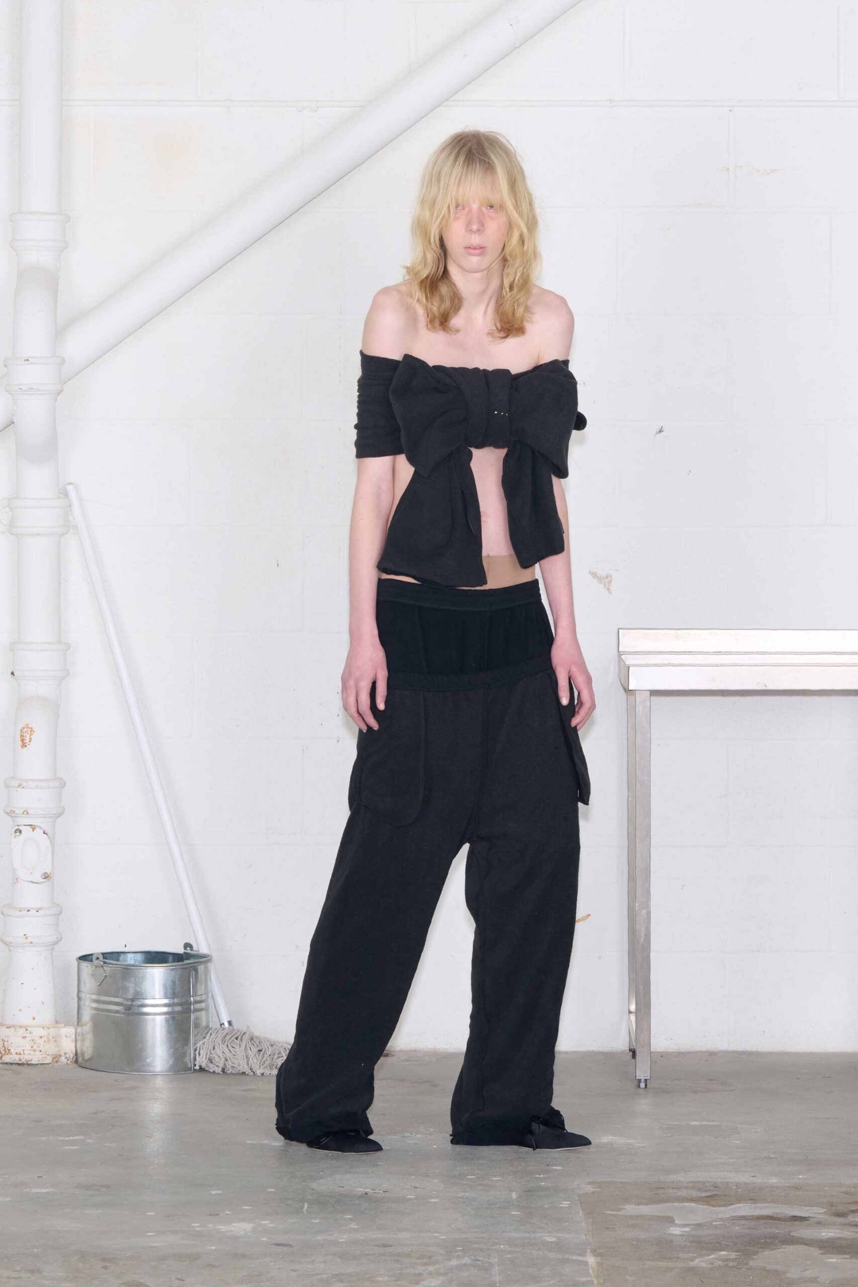 black off-shoulder top with relaxed pants