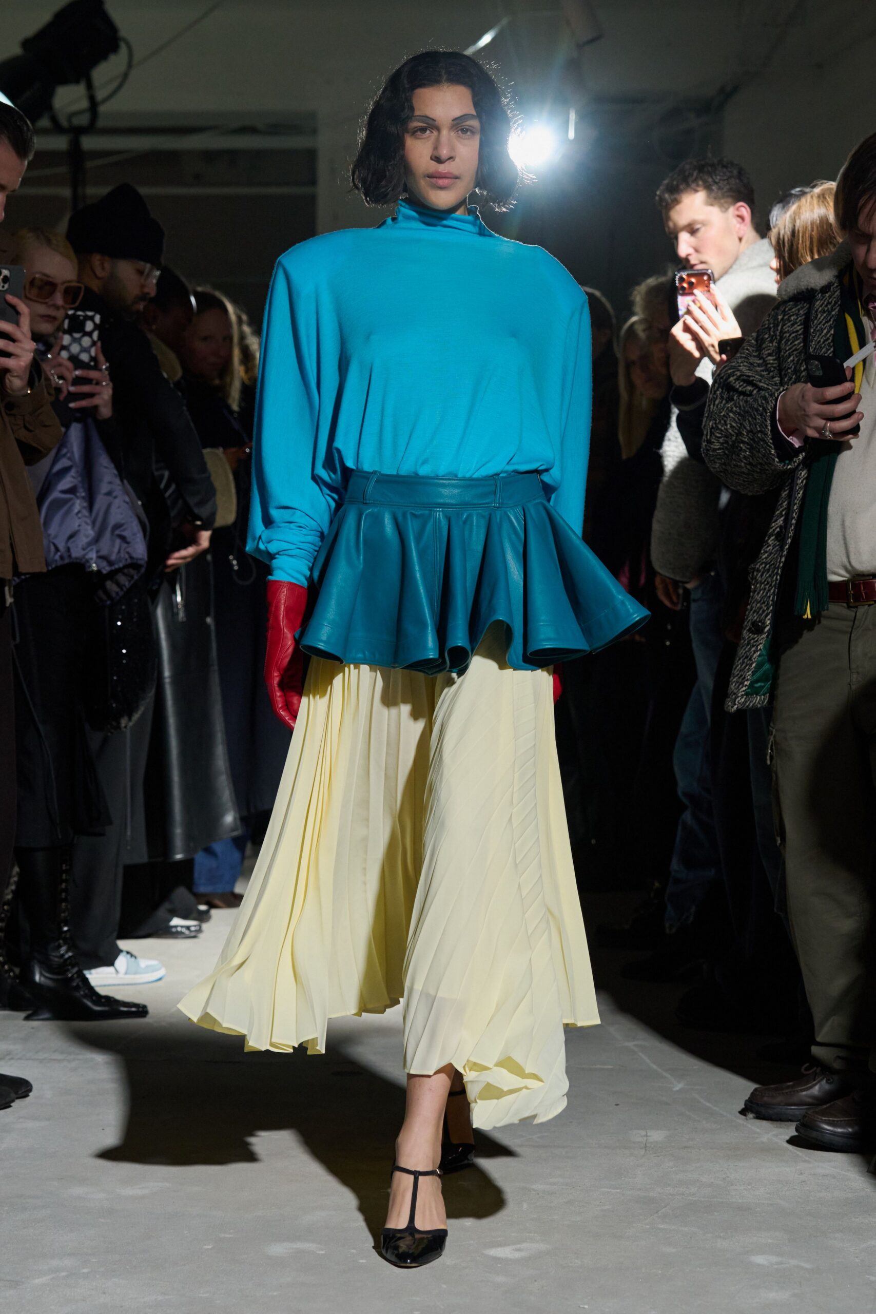 blue relaxed top with yellow pleated skirt
