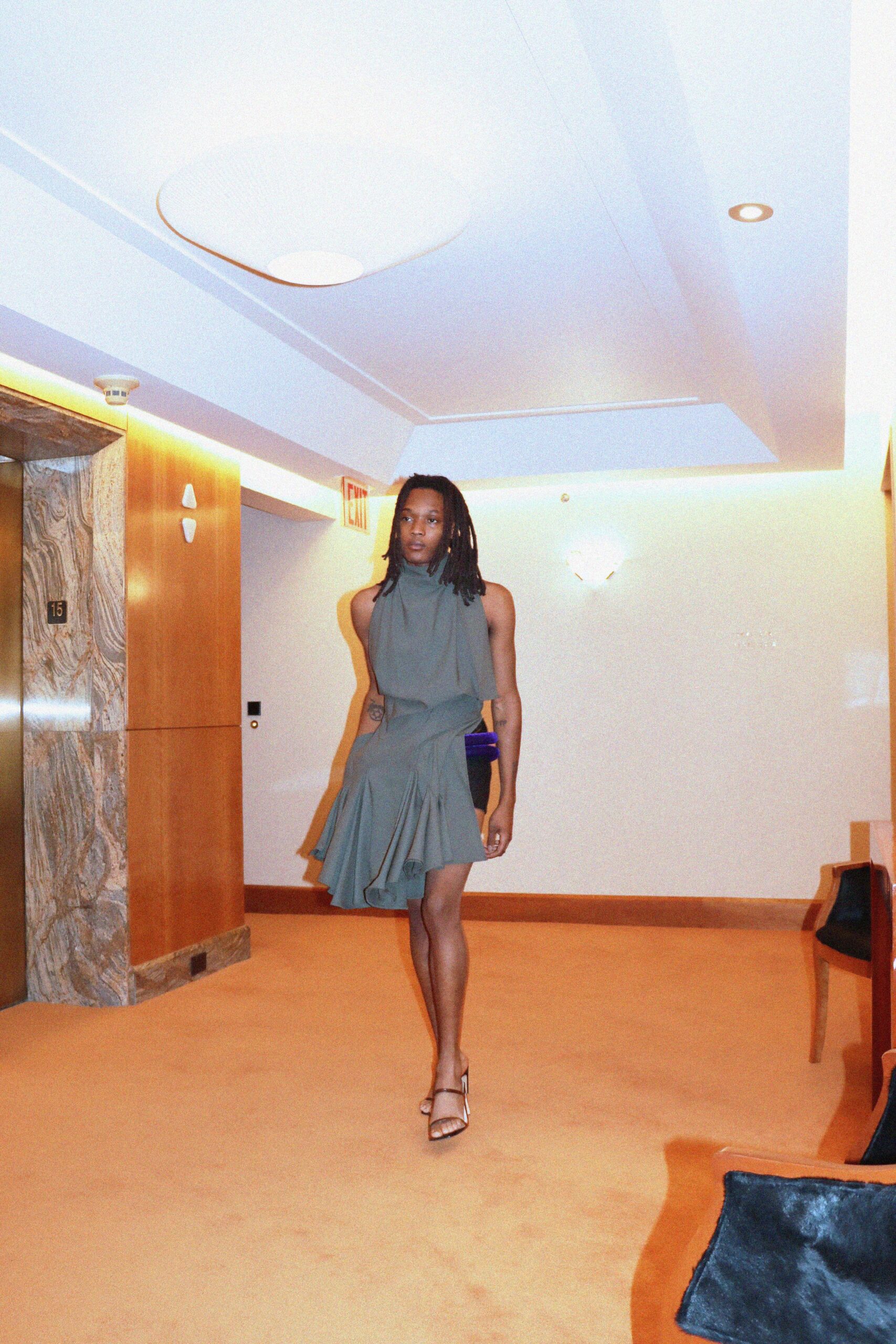 green silk sleeveless high-neck fitted pleated draped dress