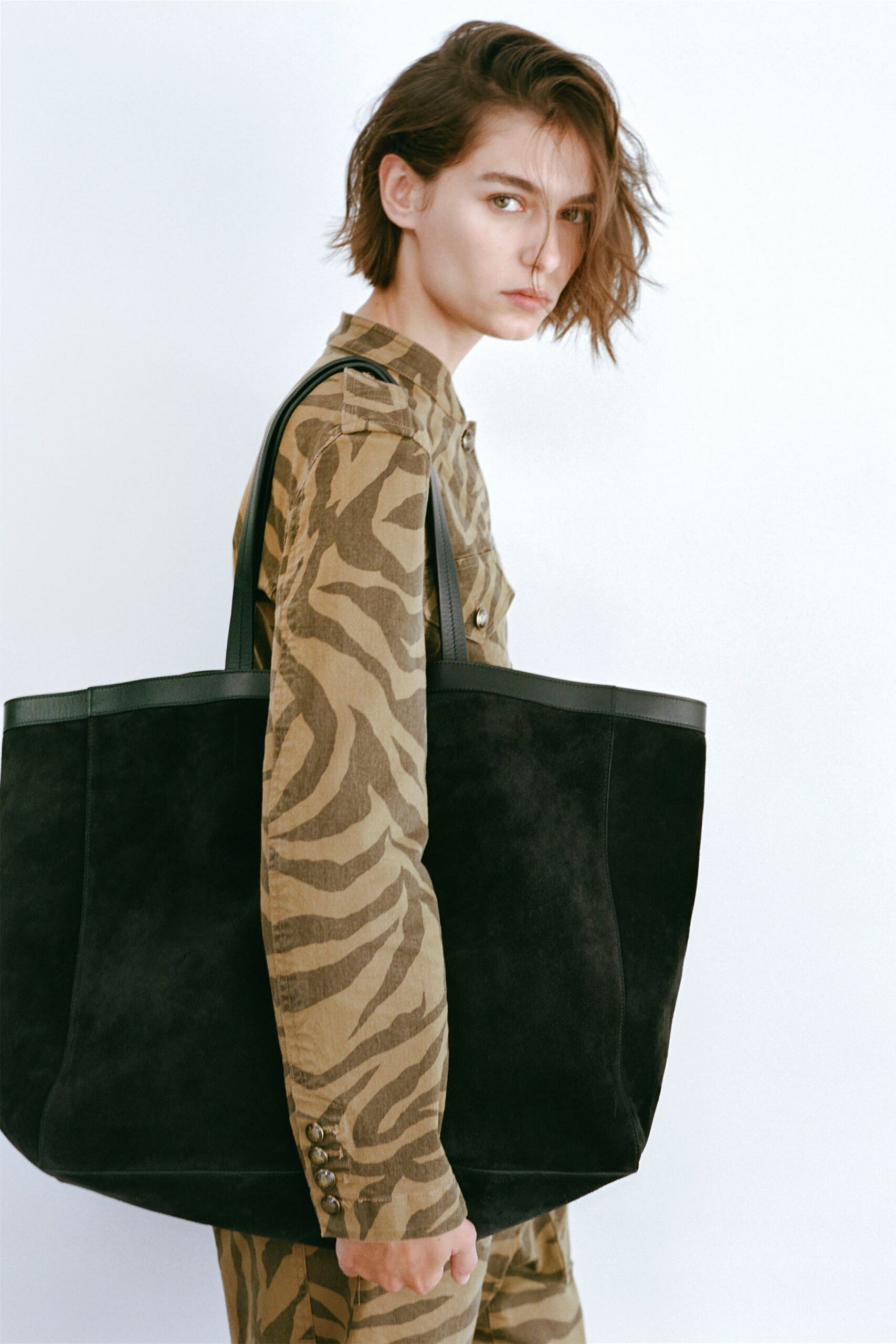 brown animal-print jumpsuit with black bag