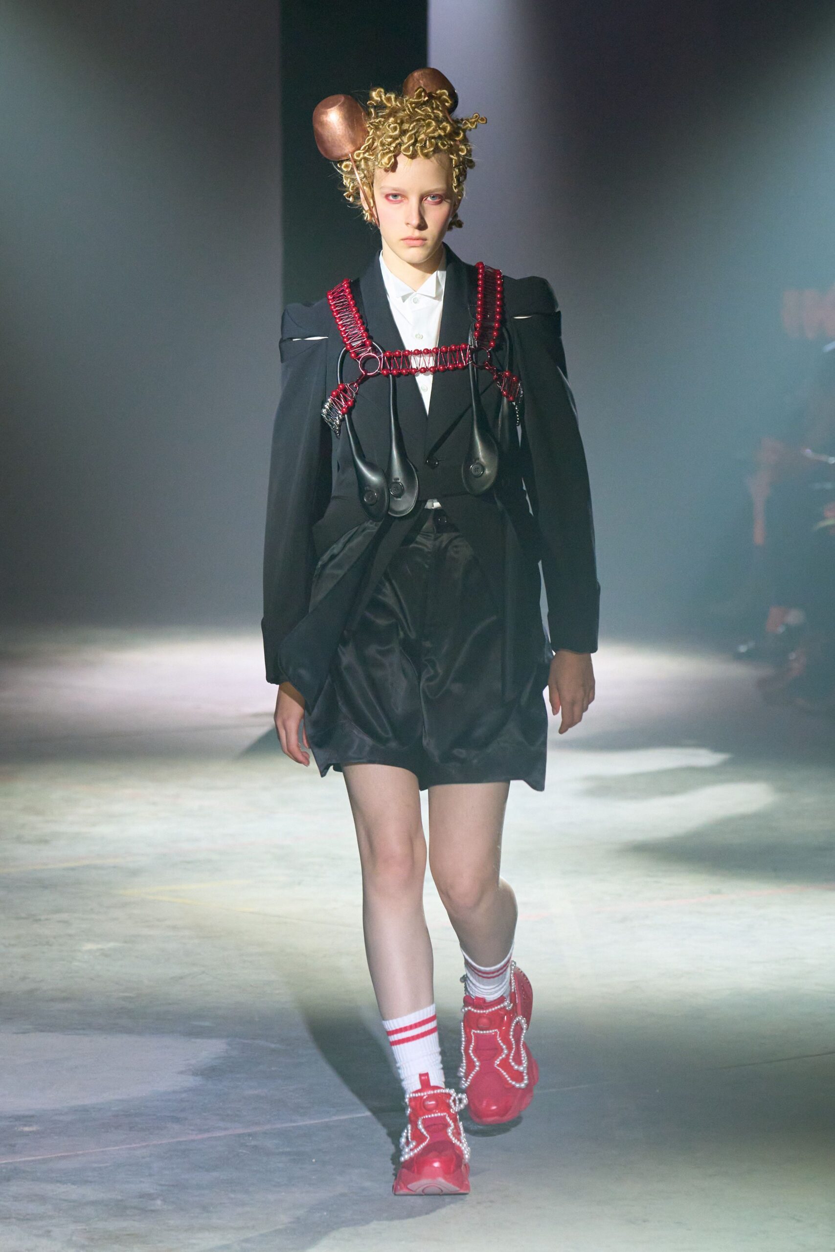 black structured jacket with red shoes