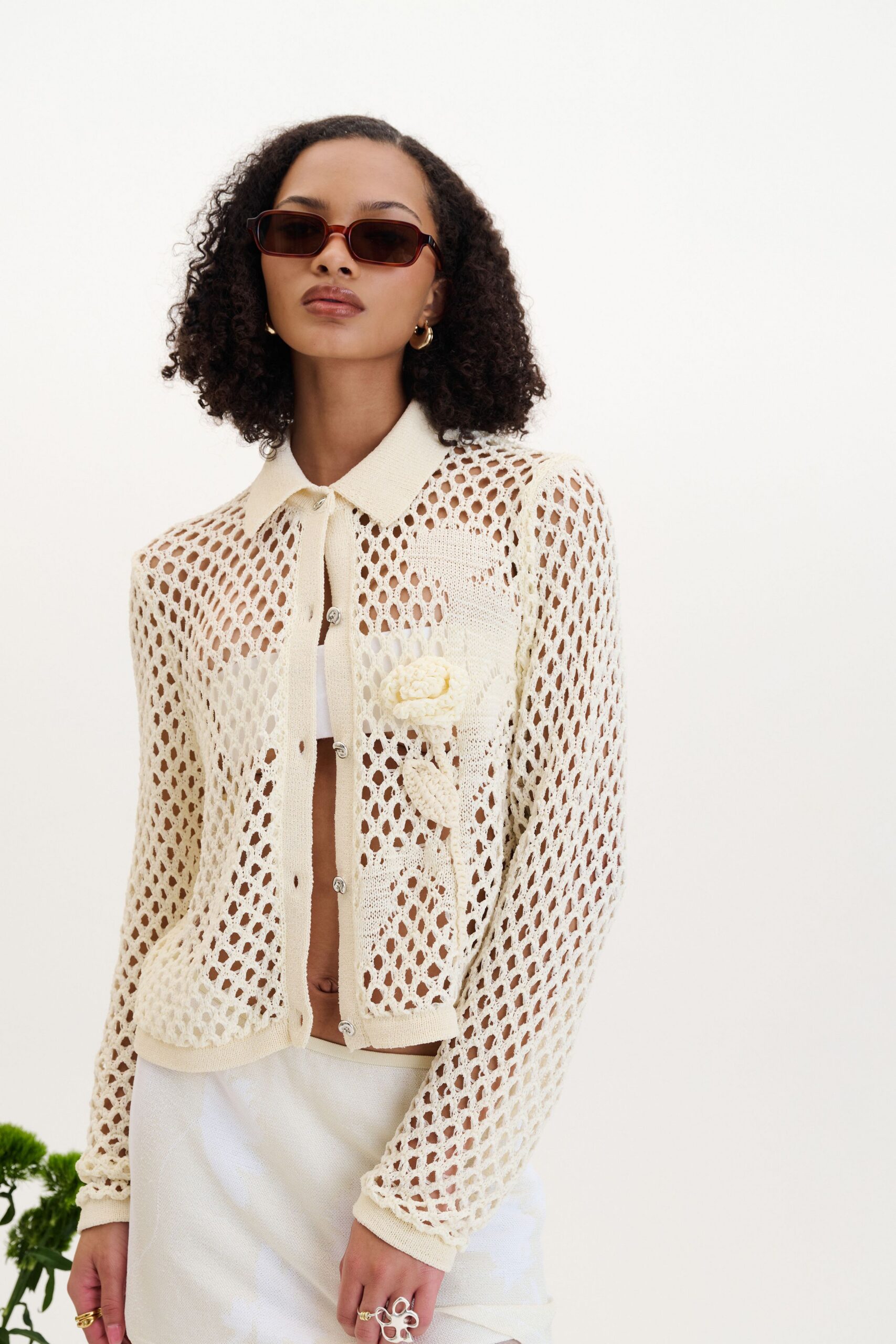 white crochet shirt and mini skirt