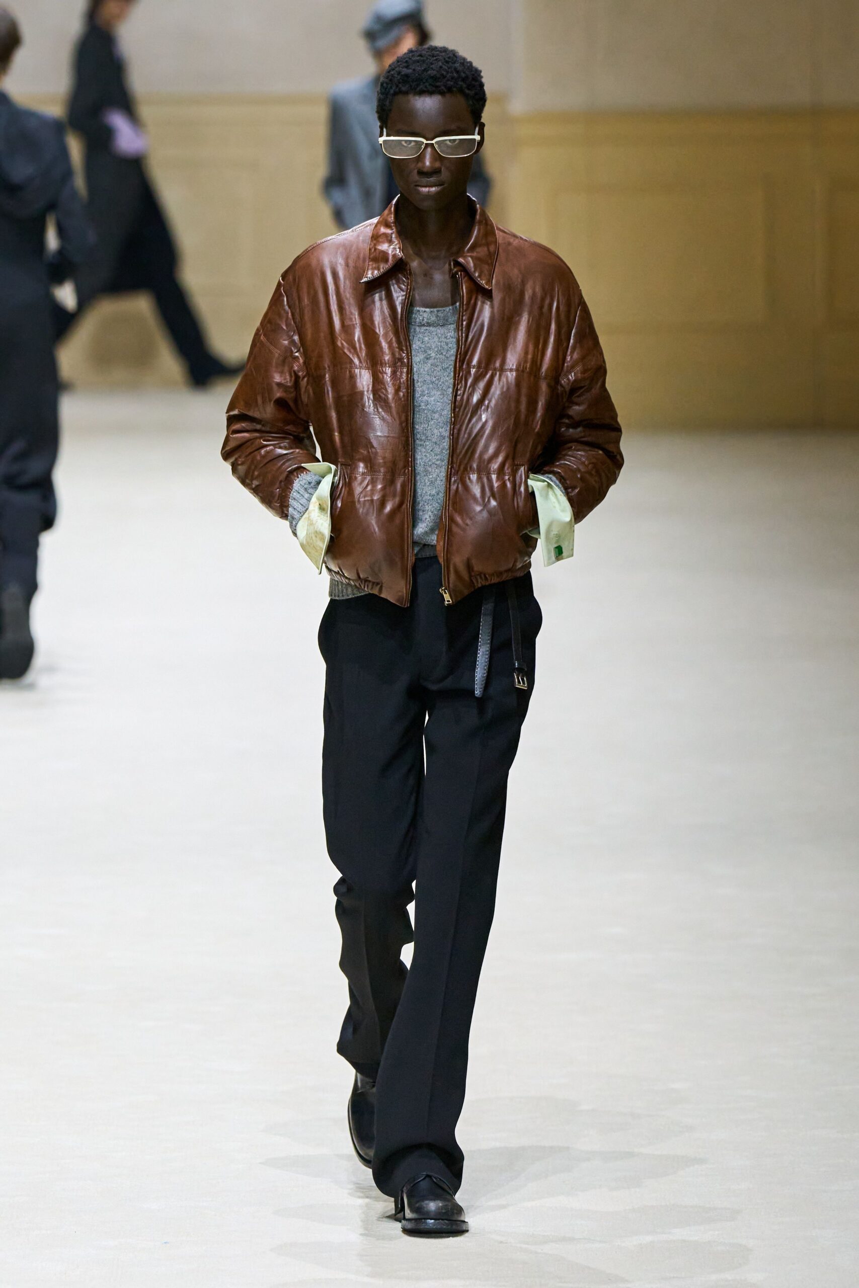 brown leather jacket with gray top
