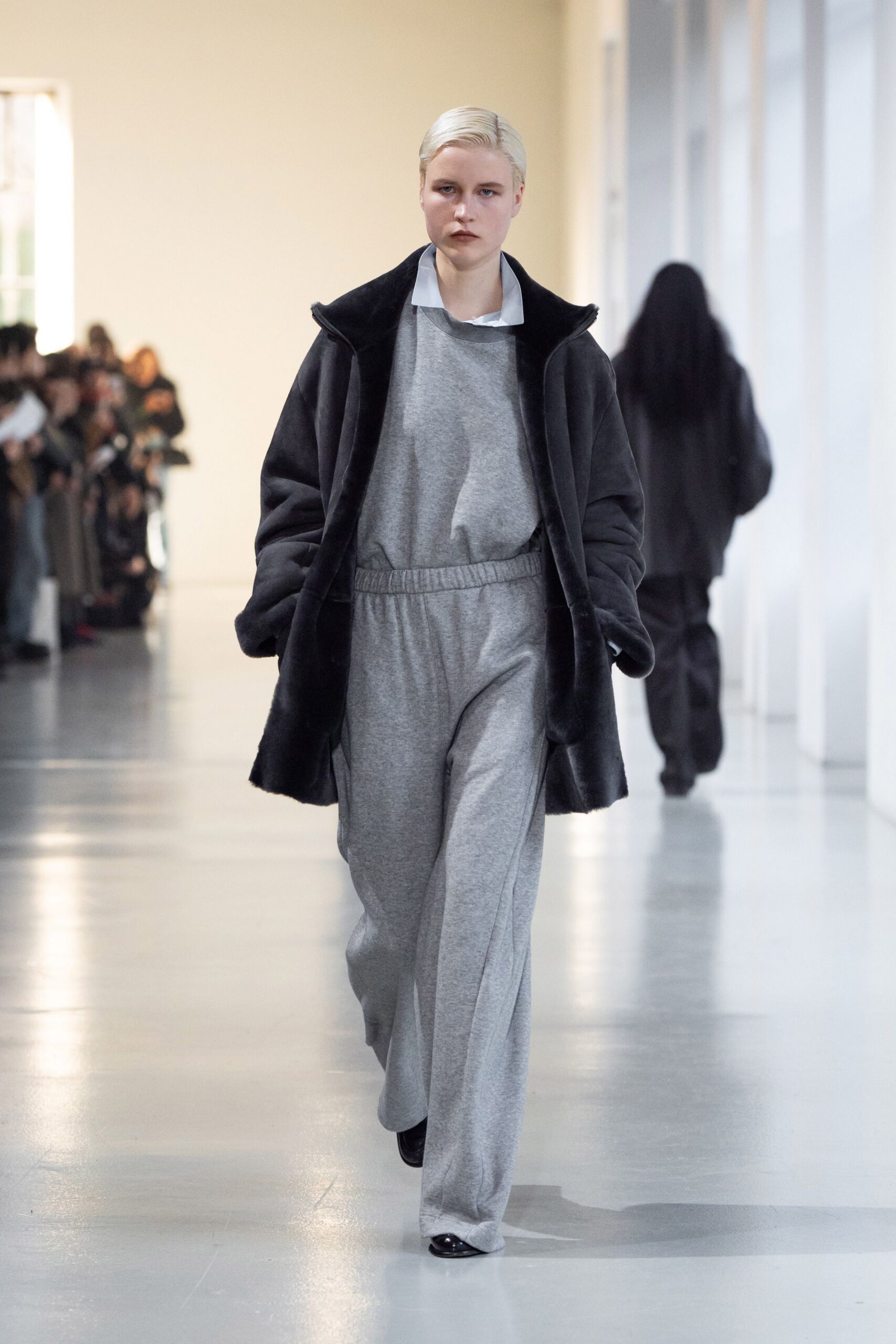 black faux-fur coat gray jumpsuit