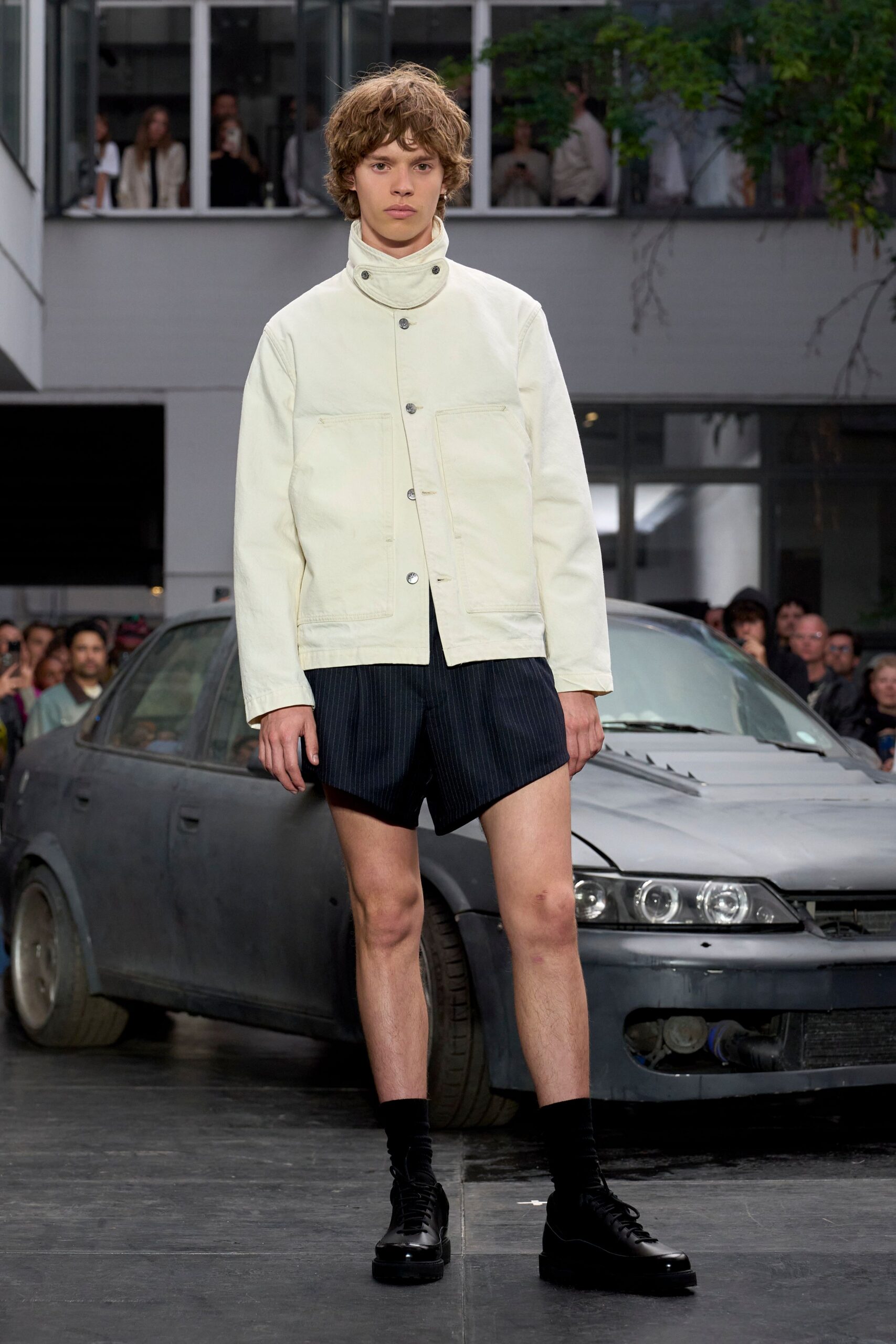 white fitted jacket with black shorts