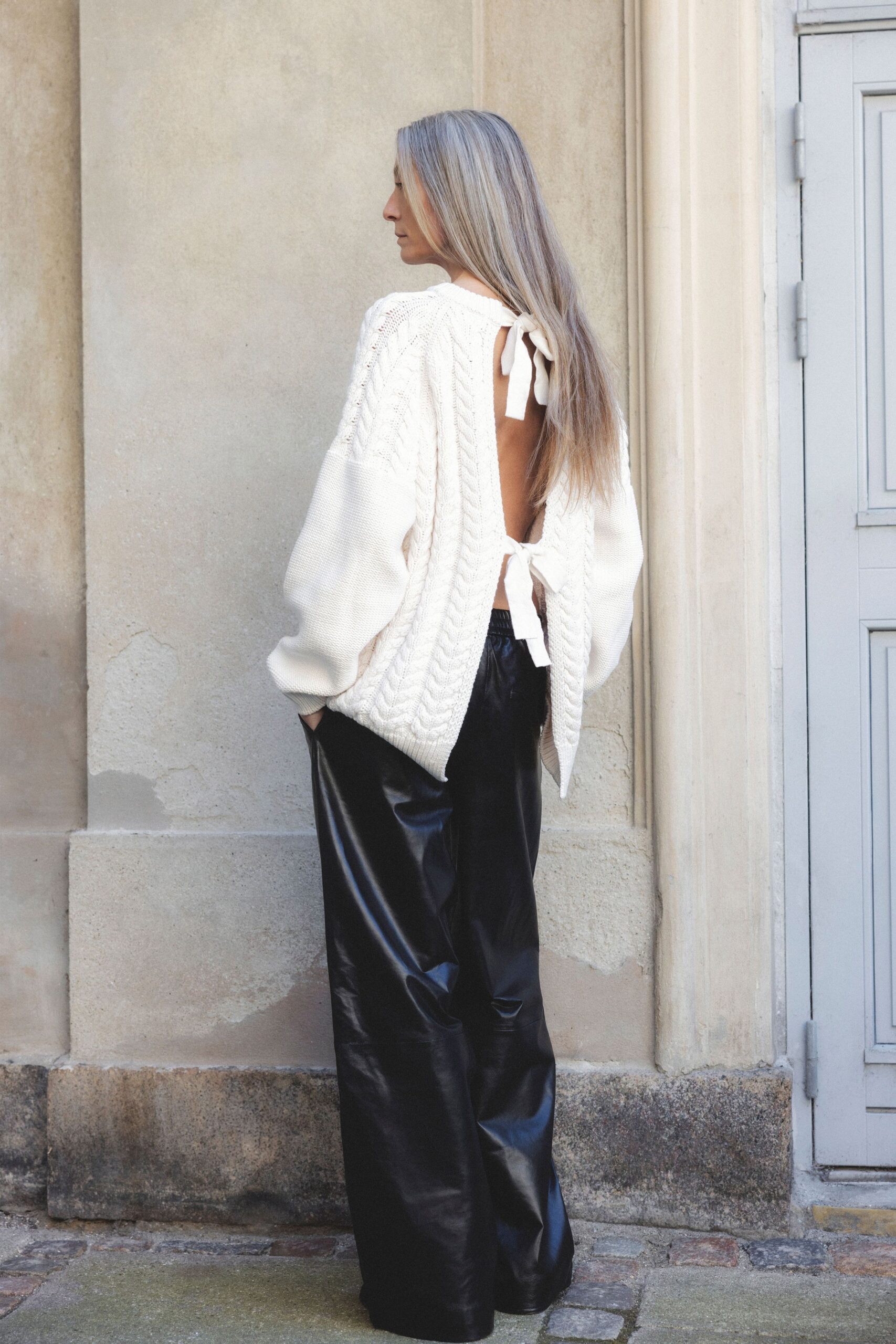 white knit sweater and black leather pants