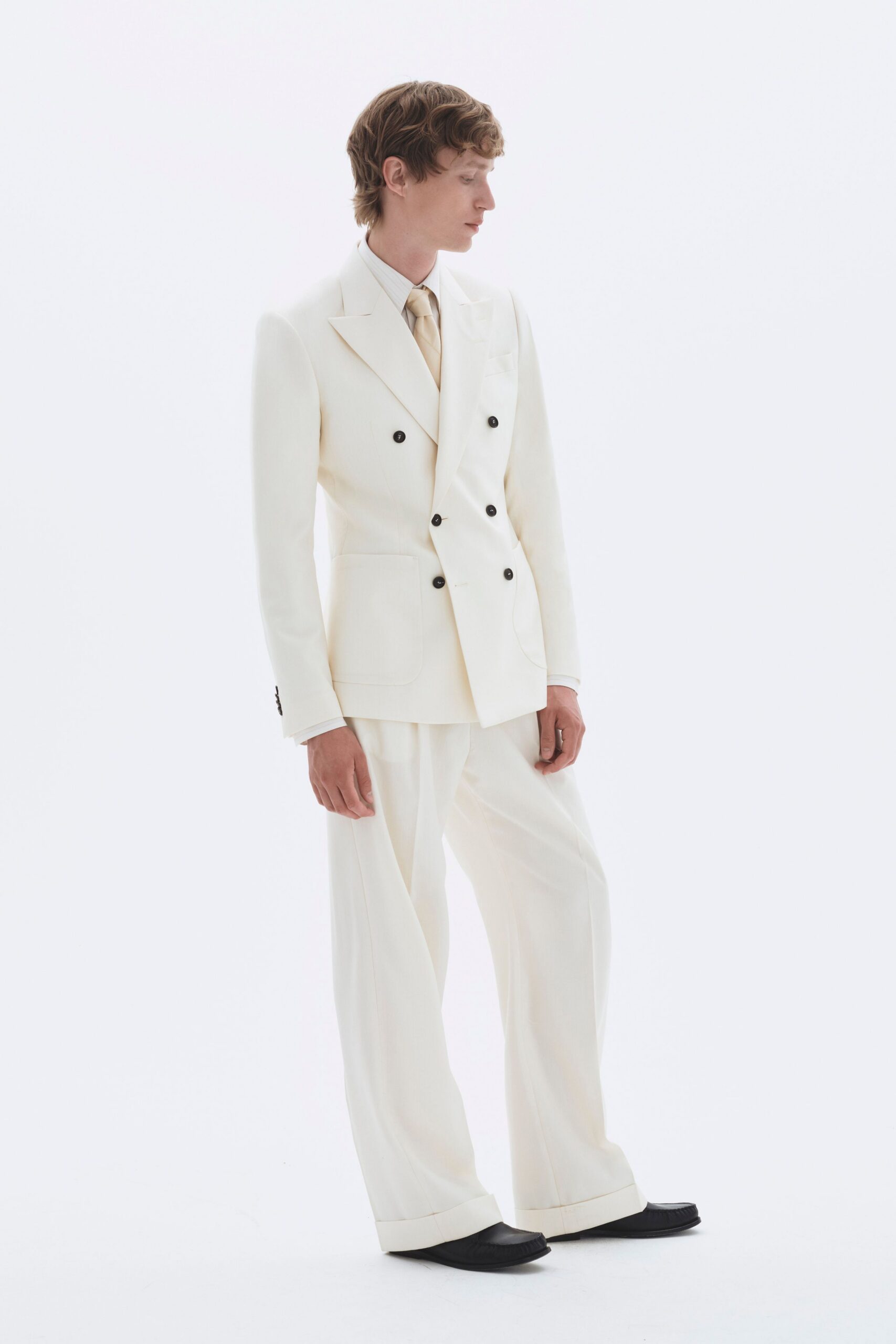 white tailored suit with black shoes