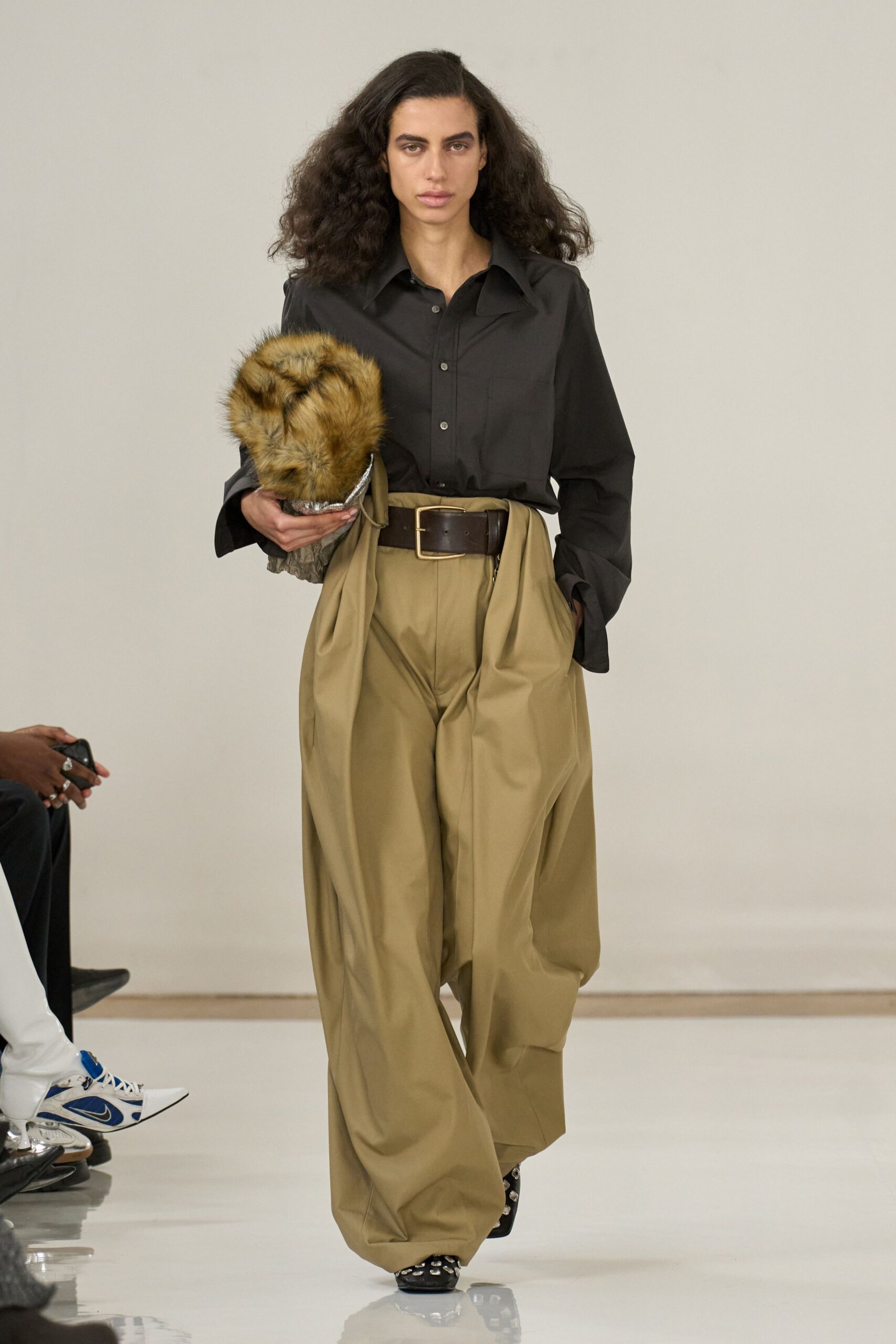 black shirt beige pleated pants