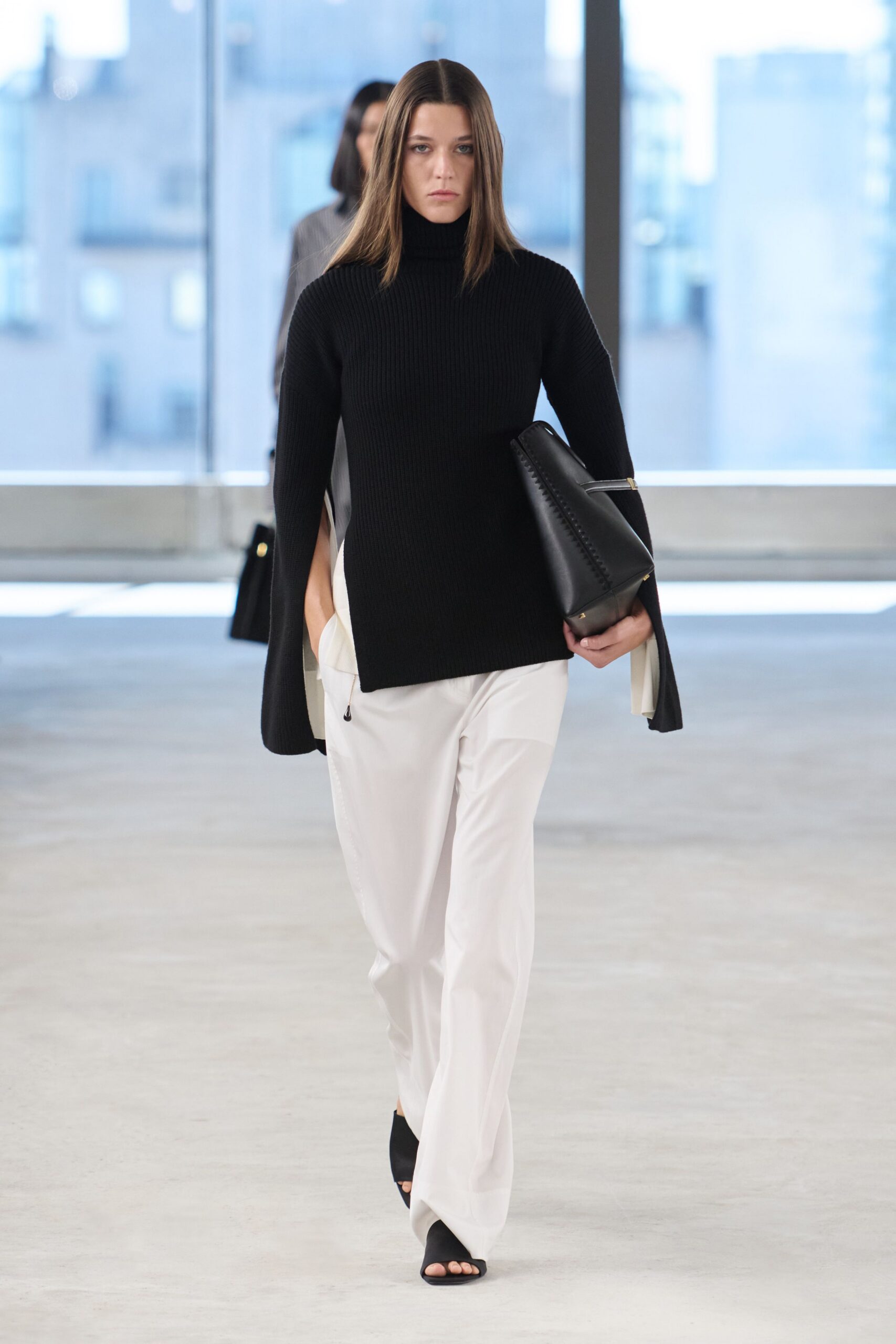 black wool fitted top with white pants
