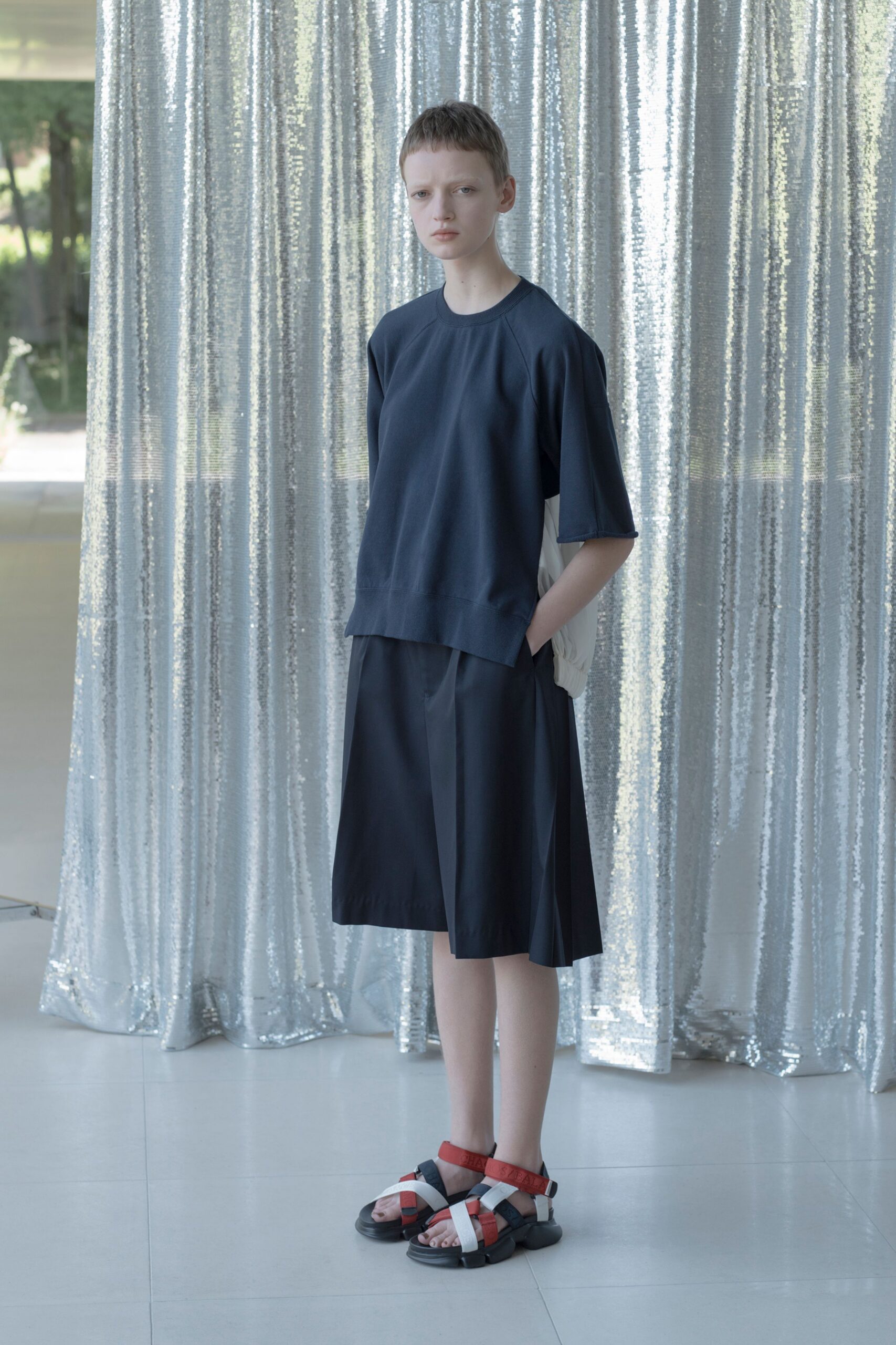 blue relaxed top black pleated skirt