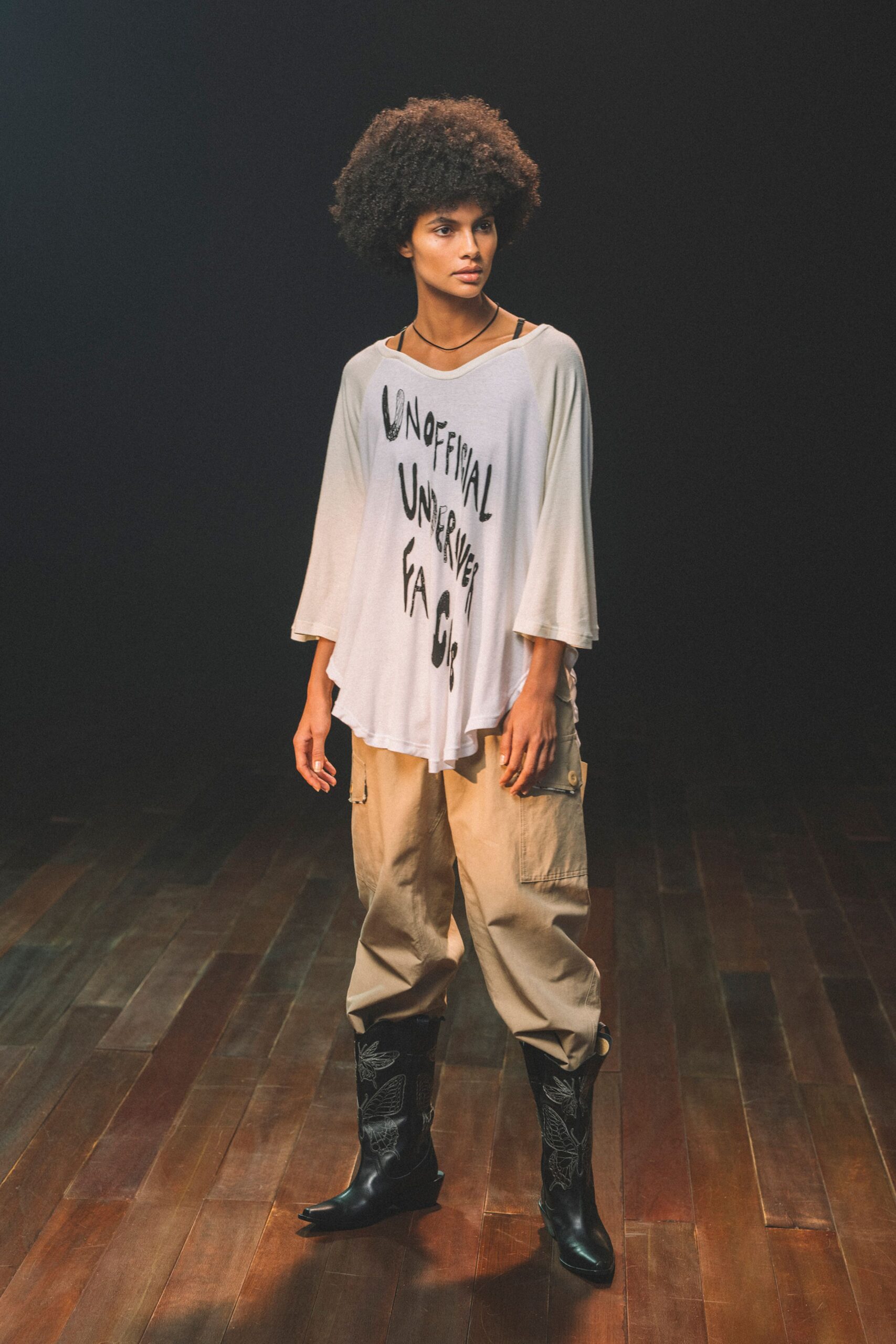 white relaxed top beige cargo pants black embroidered boots