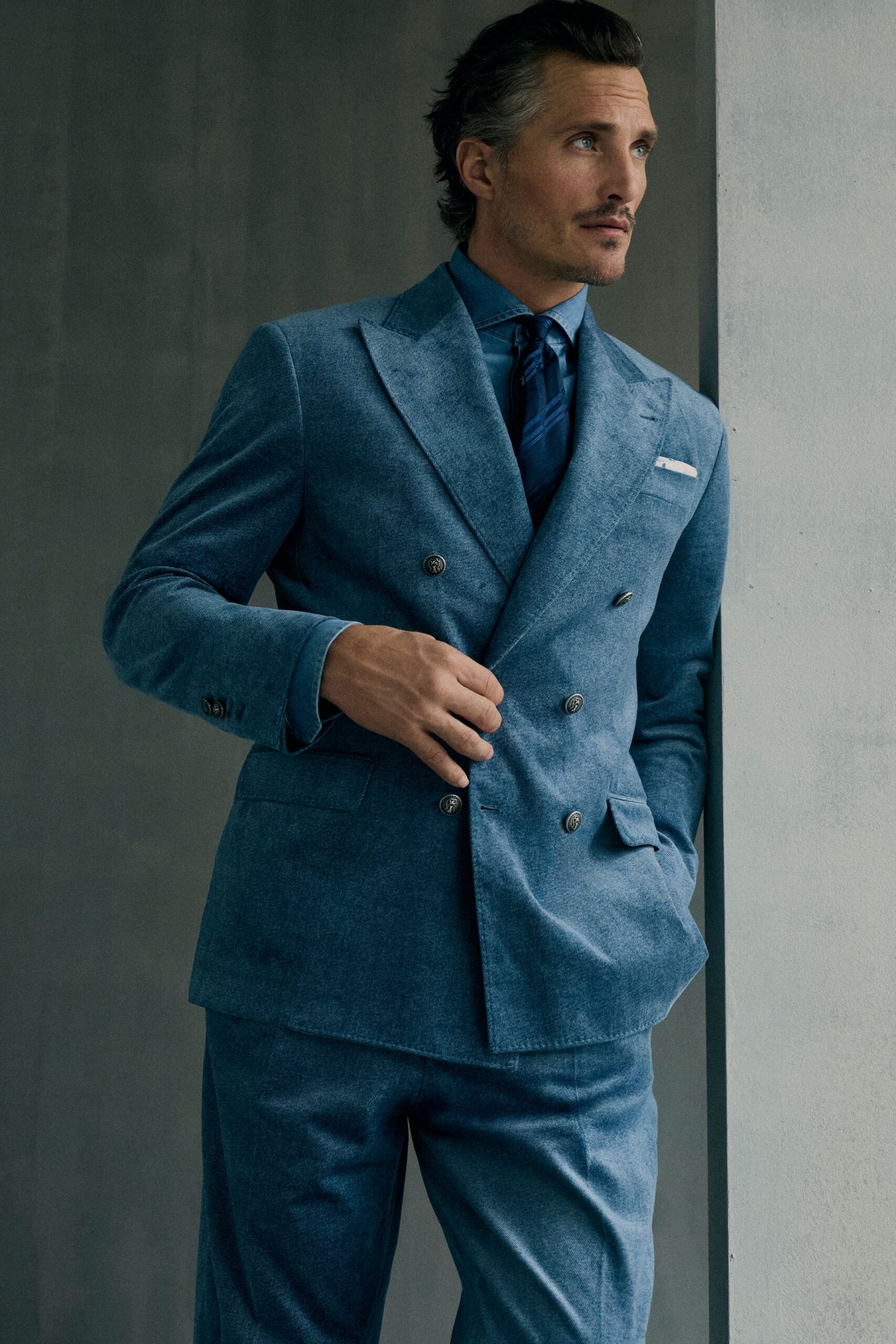 blue tailored suit with tie