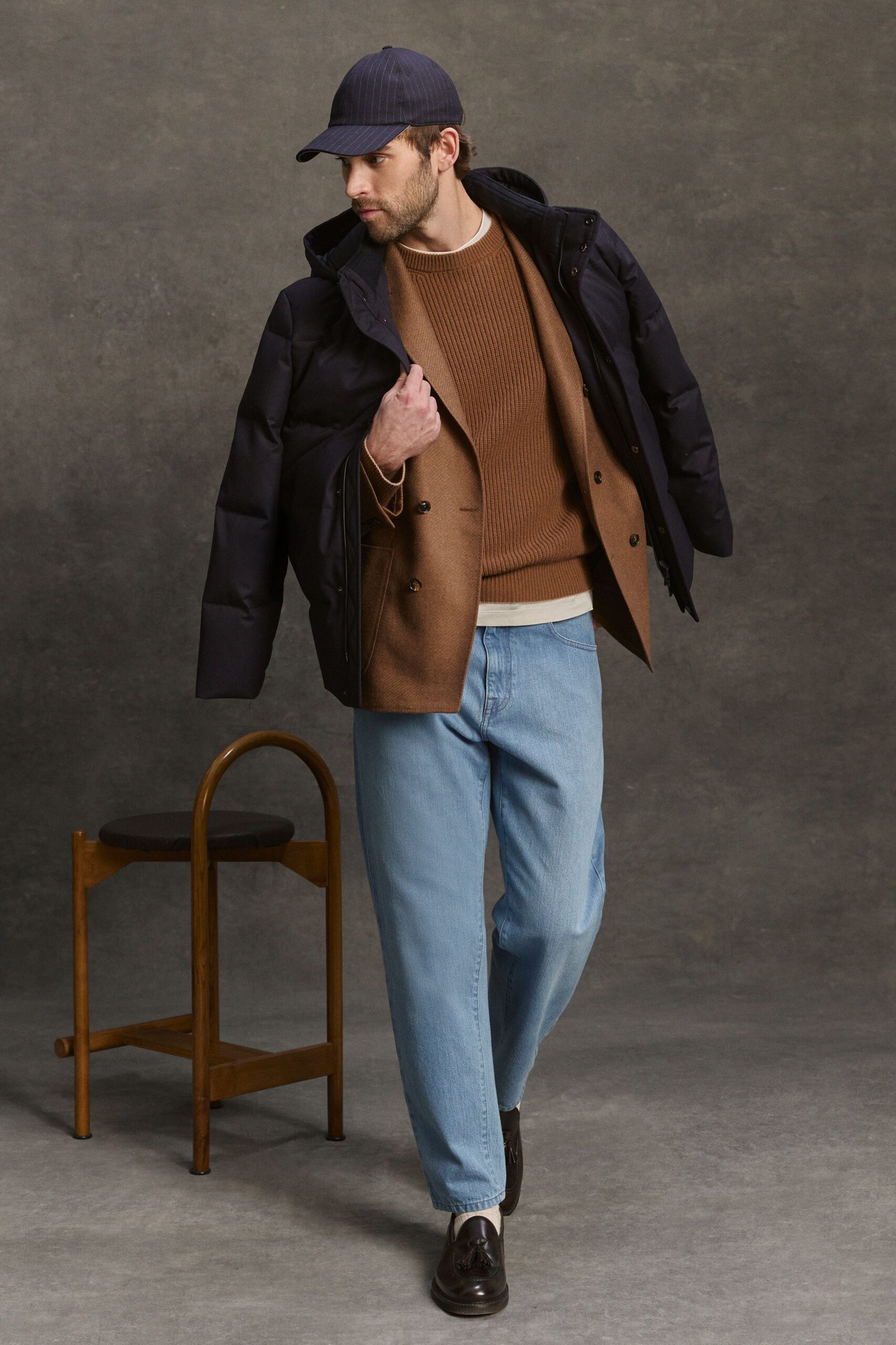 black coat brown sweater blue pants