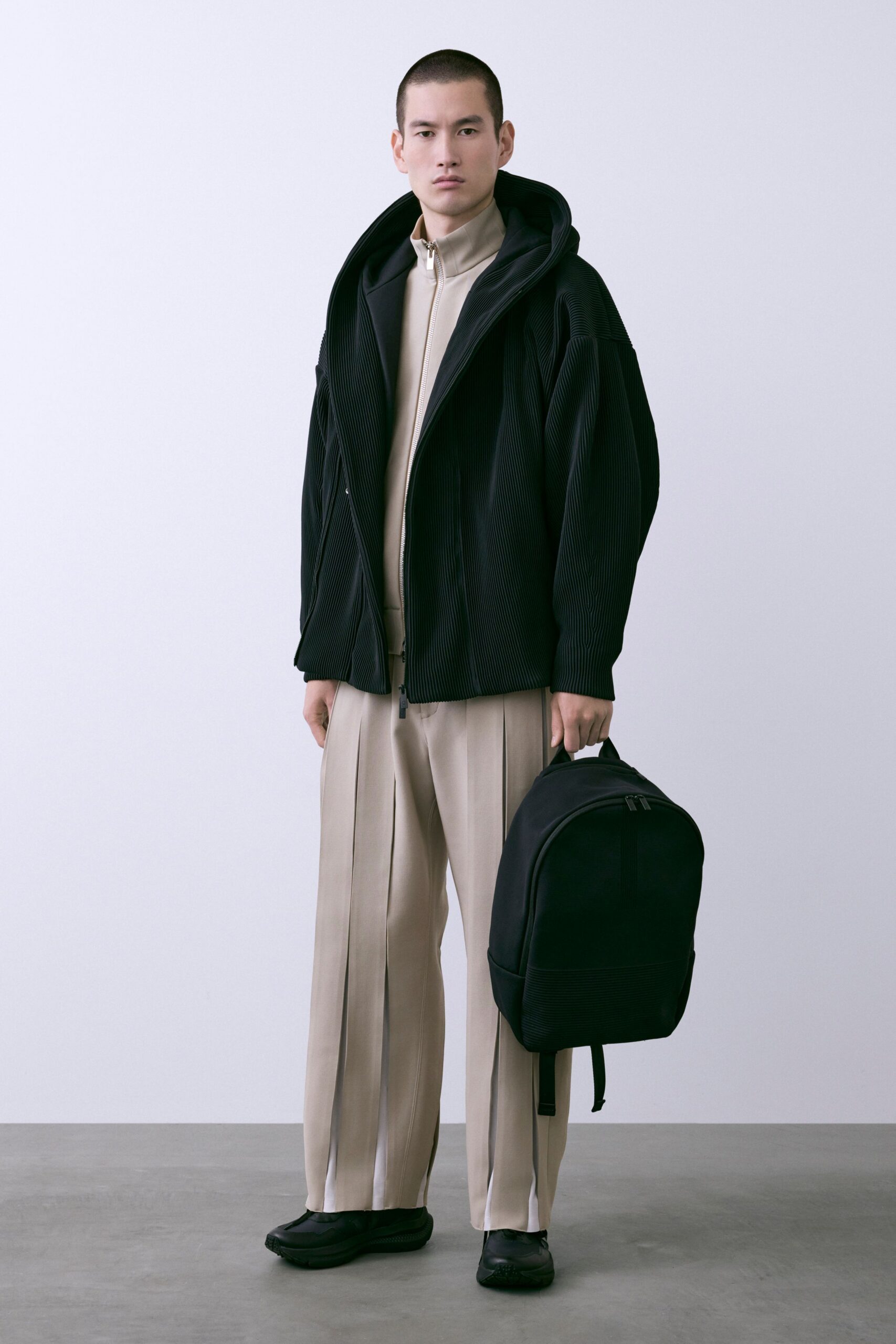 black jacket beige top pants