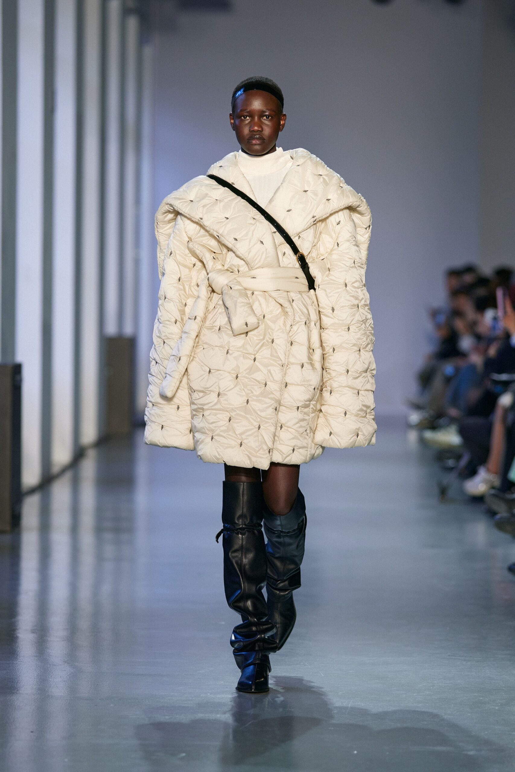 white quilted coat with black boots