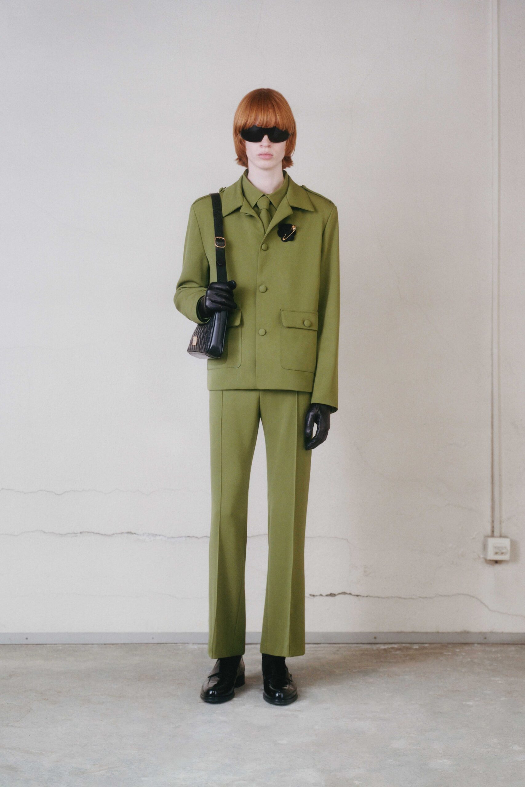 green tailored suit with accessories