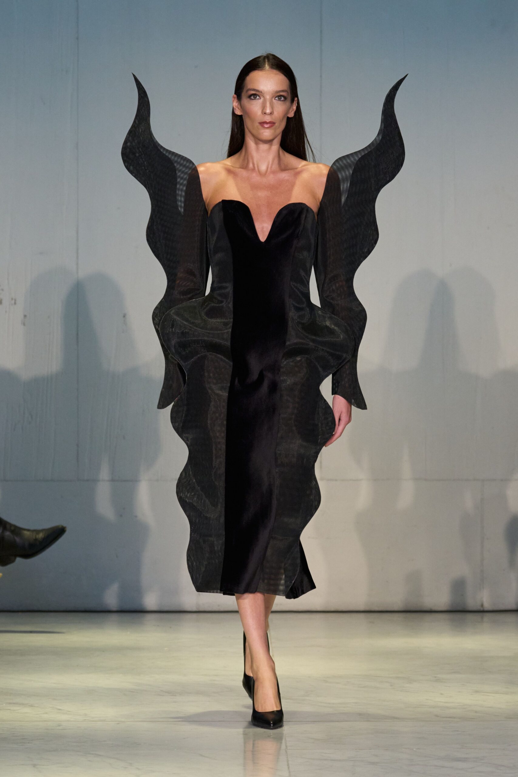 black fitted midi dress with dramatic sleeves