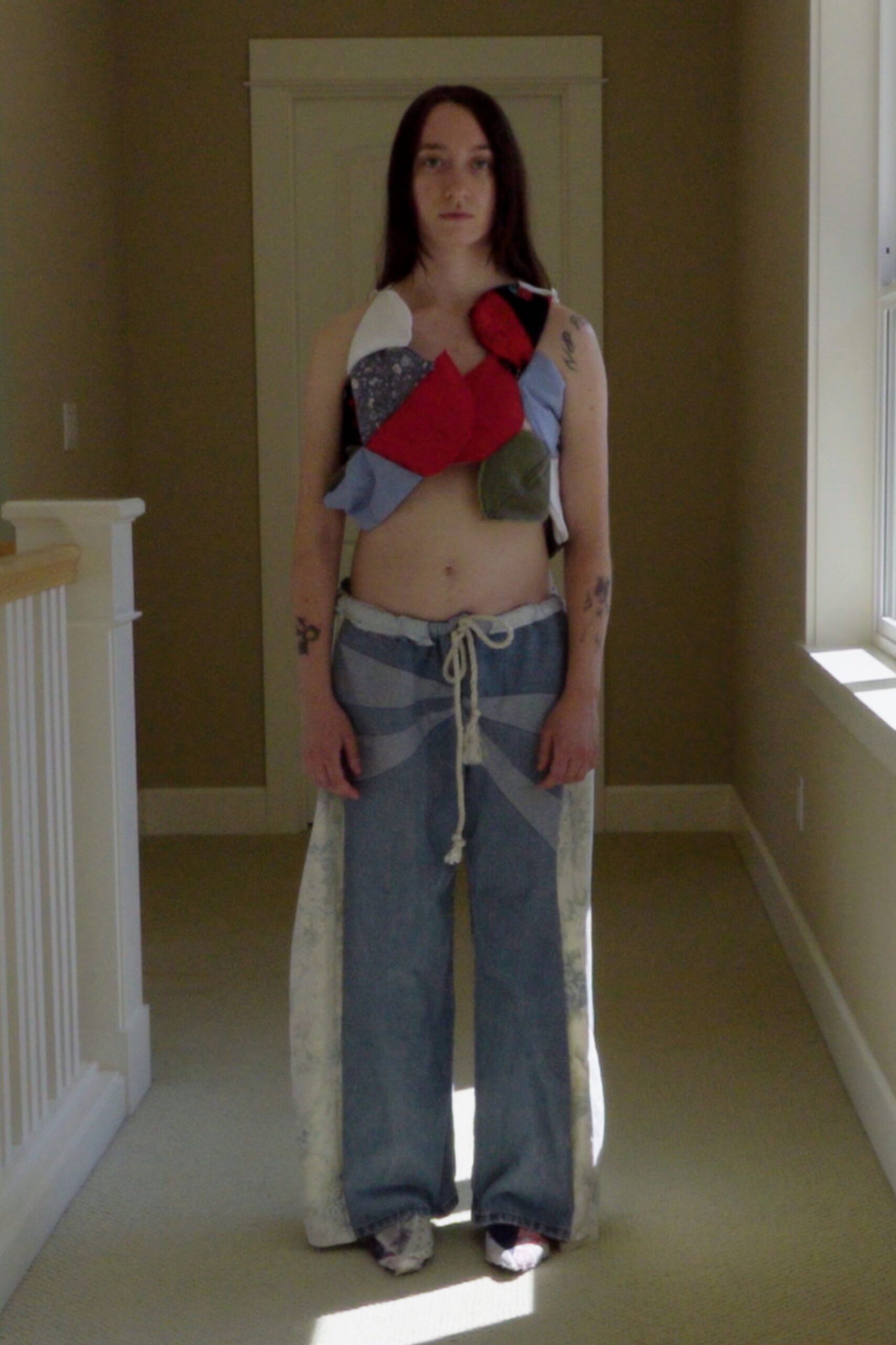 multi-colored sleeveless top with relaxed jeans