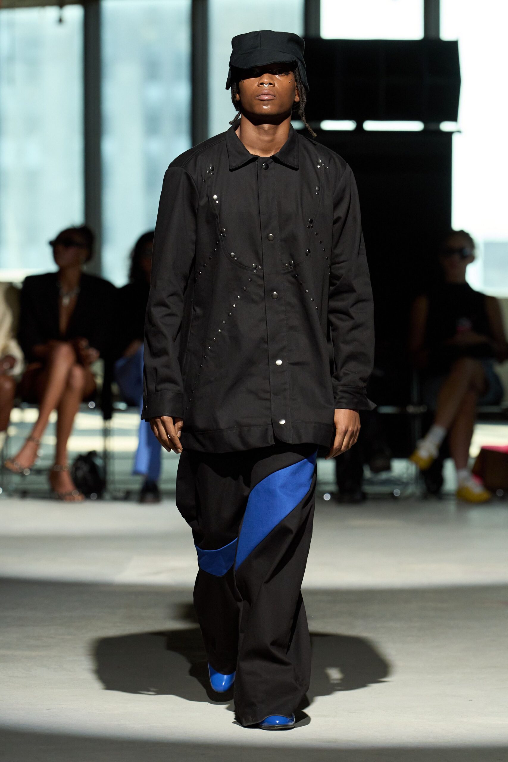 black shirt relaxed pants blue shoes