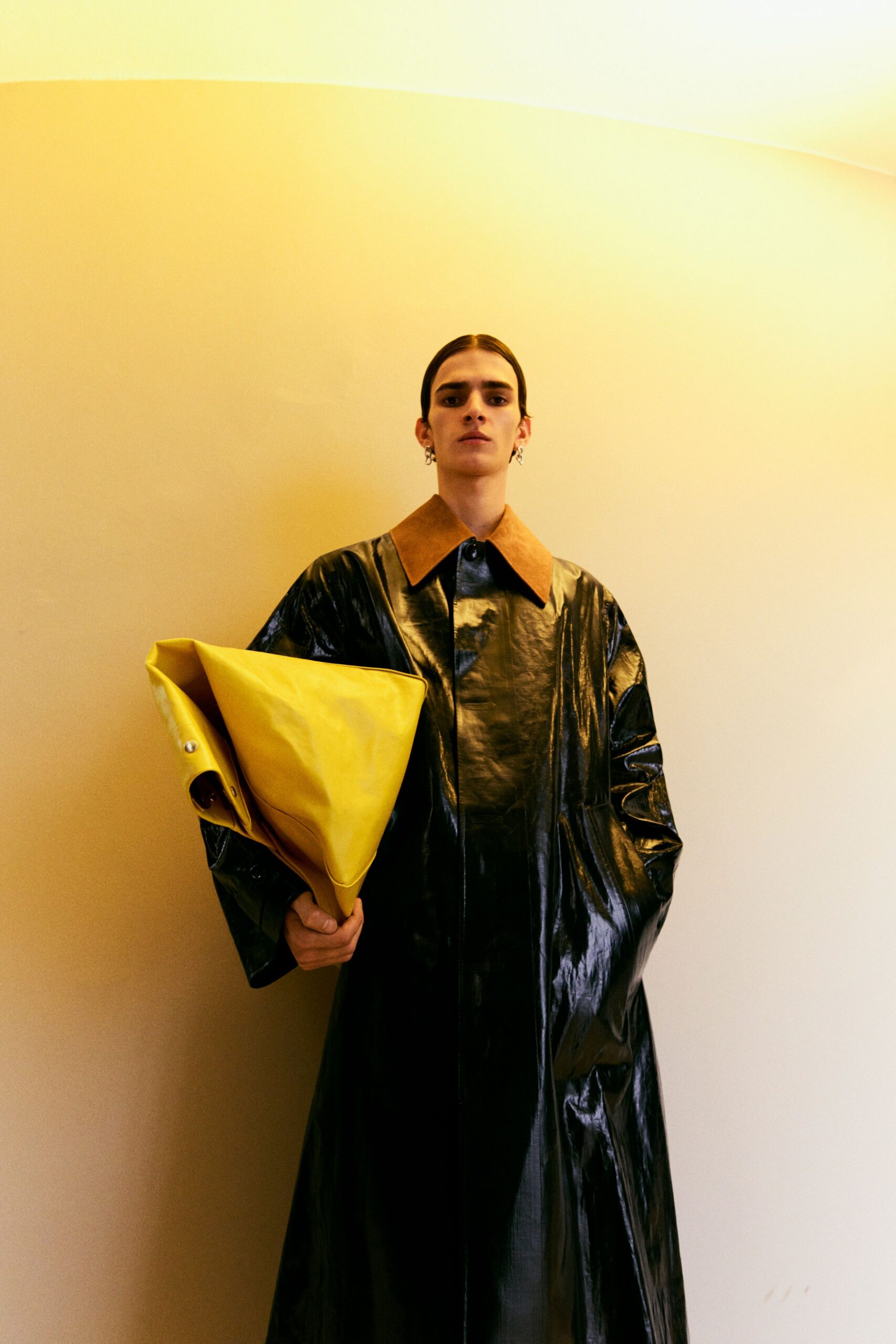 black vinyl relaxed coat with yellow bag