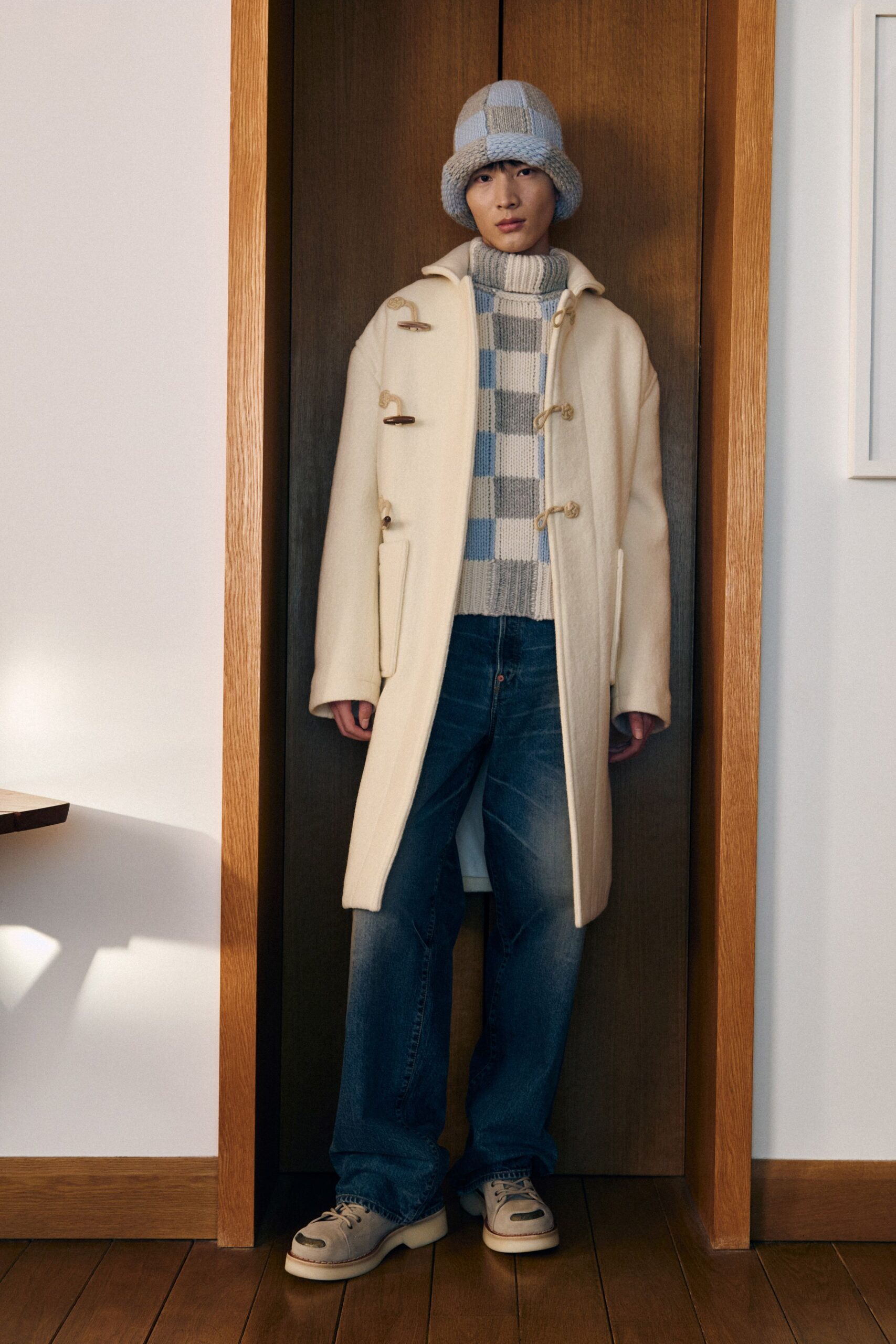 white wool coat with blue sweater