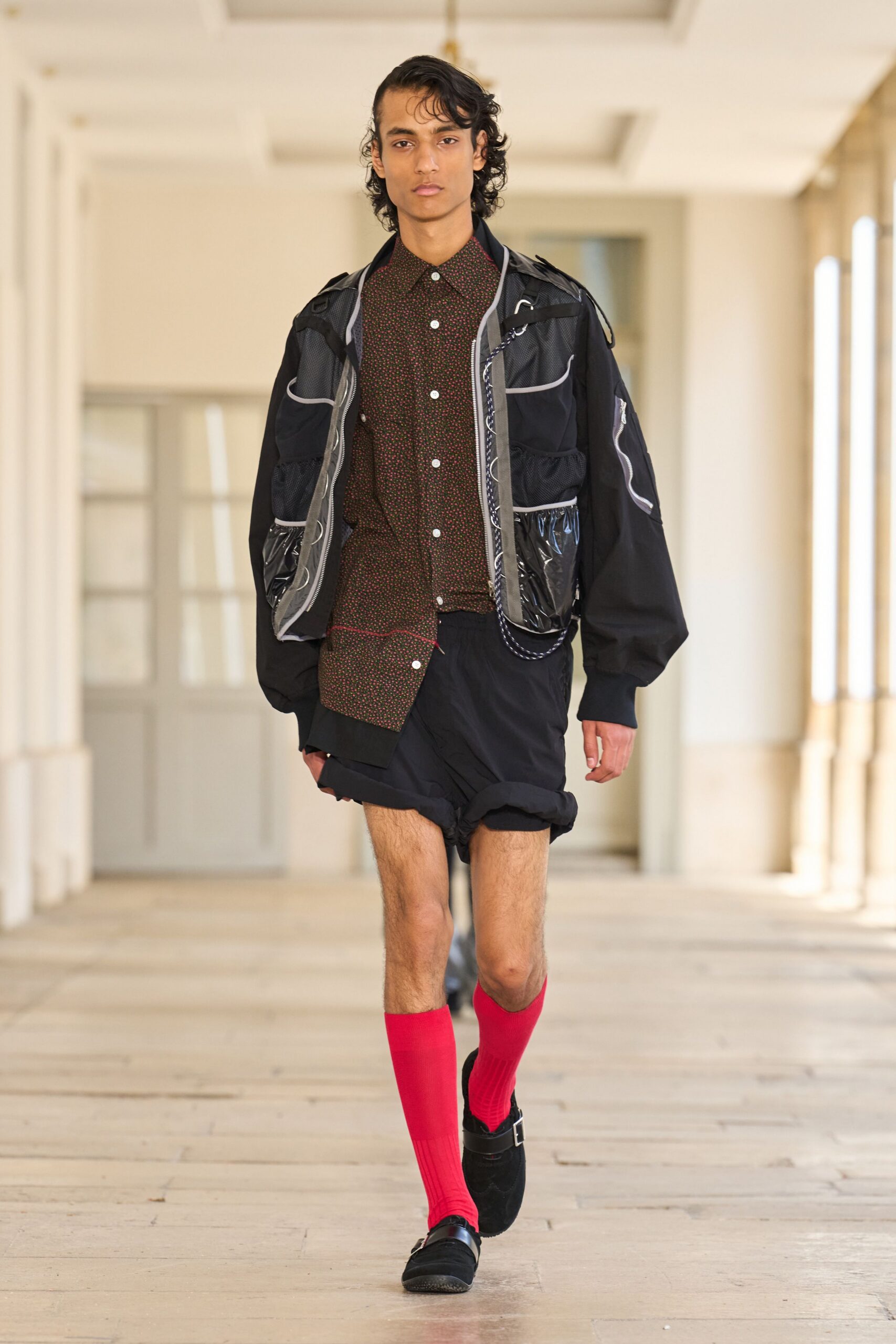 black jacket brown shirt black shorts