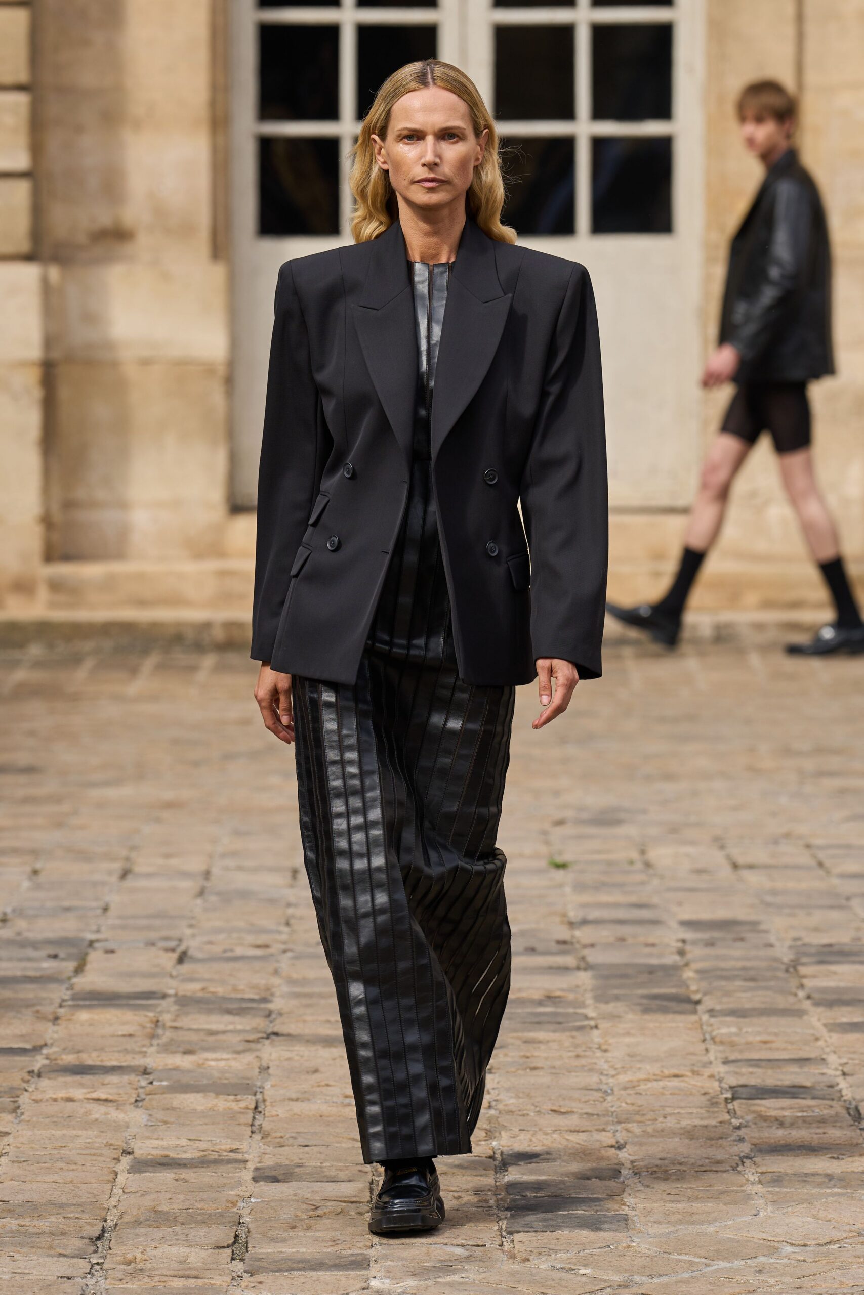 black blazer and pleated pants