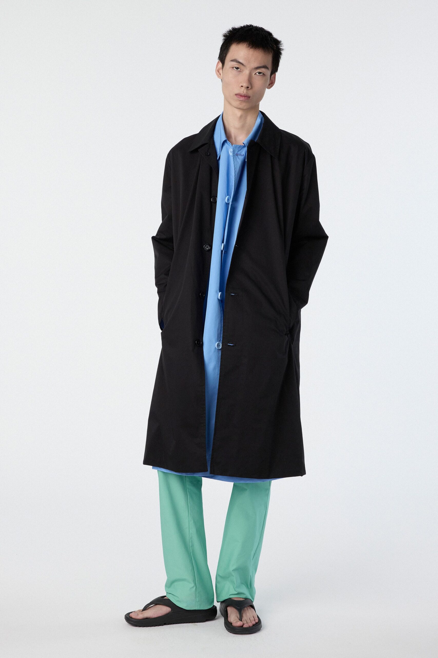 black coat blue shirt green pants