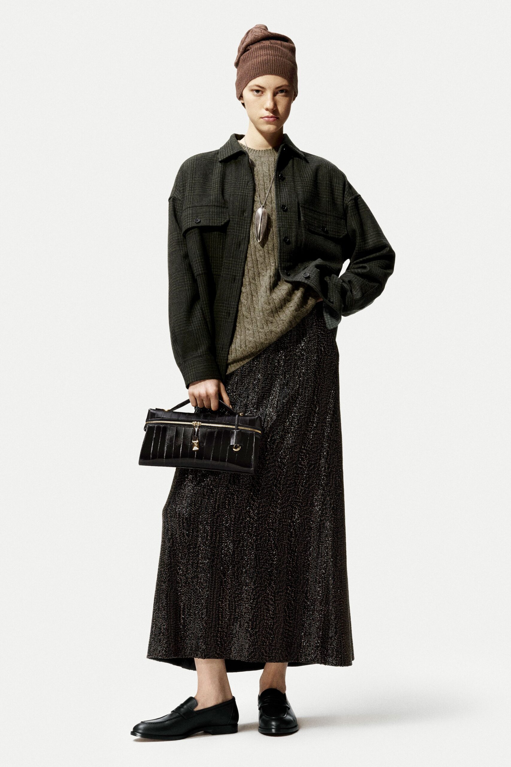 green shirt beige sweater black skirt