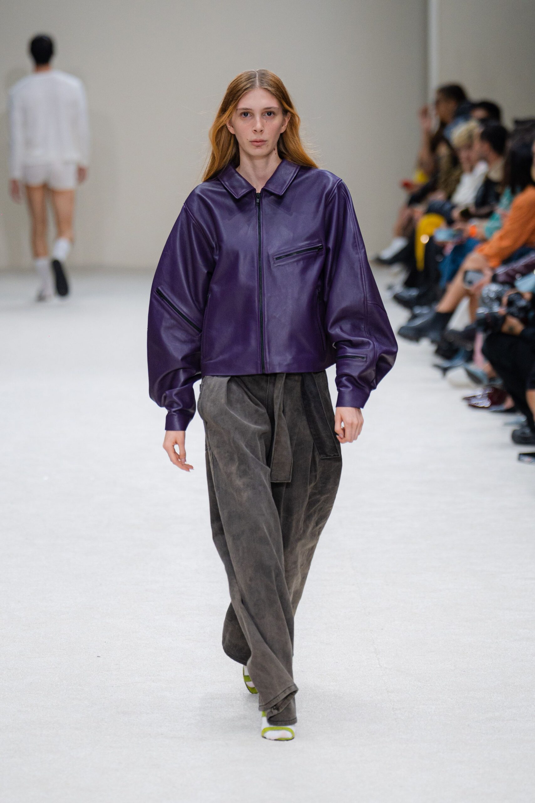 purple leather relaxed jacket and gray pants