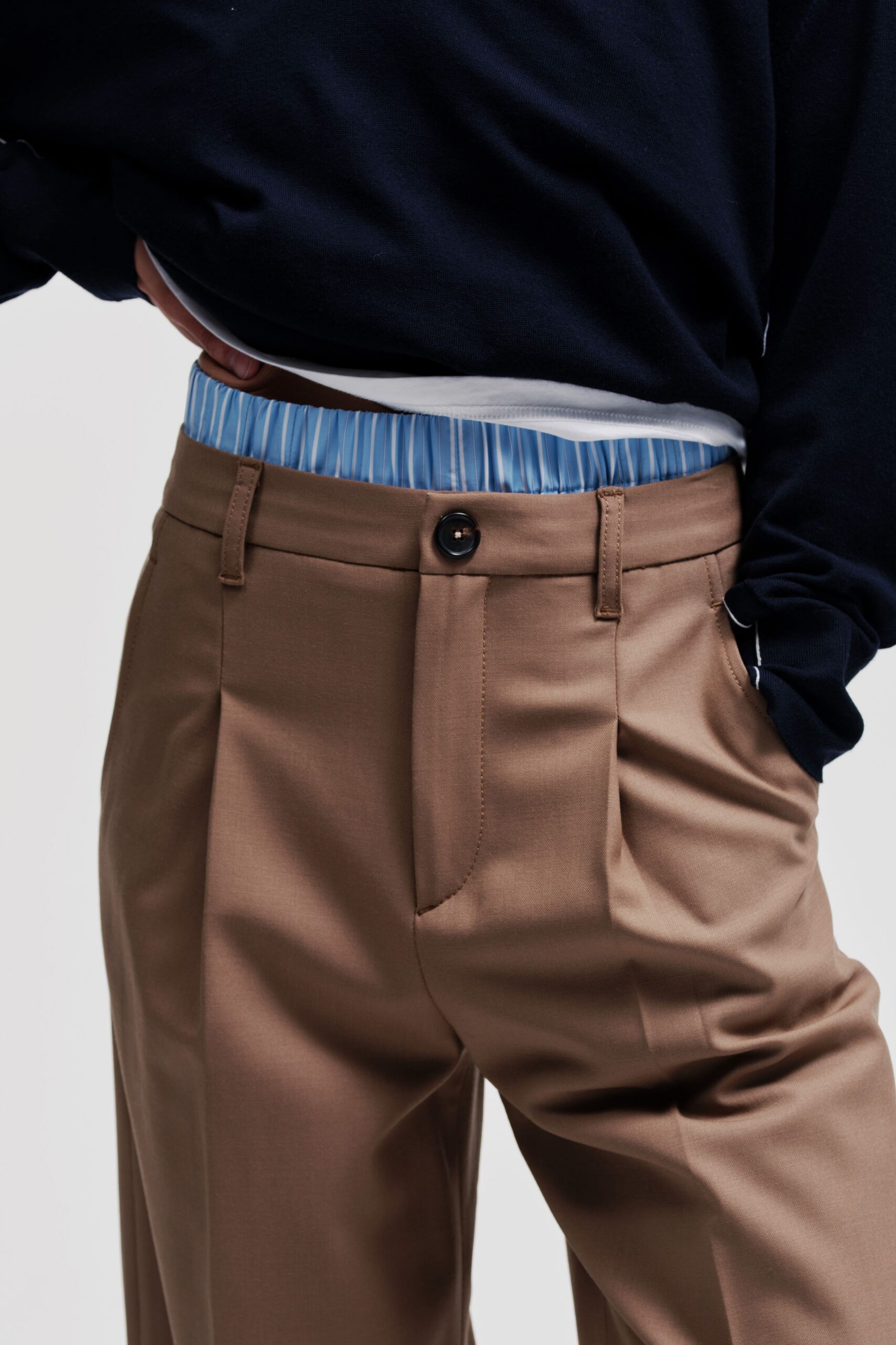 brown tailored pants with blue top