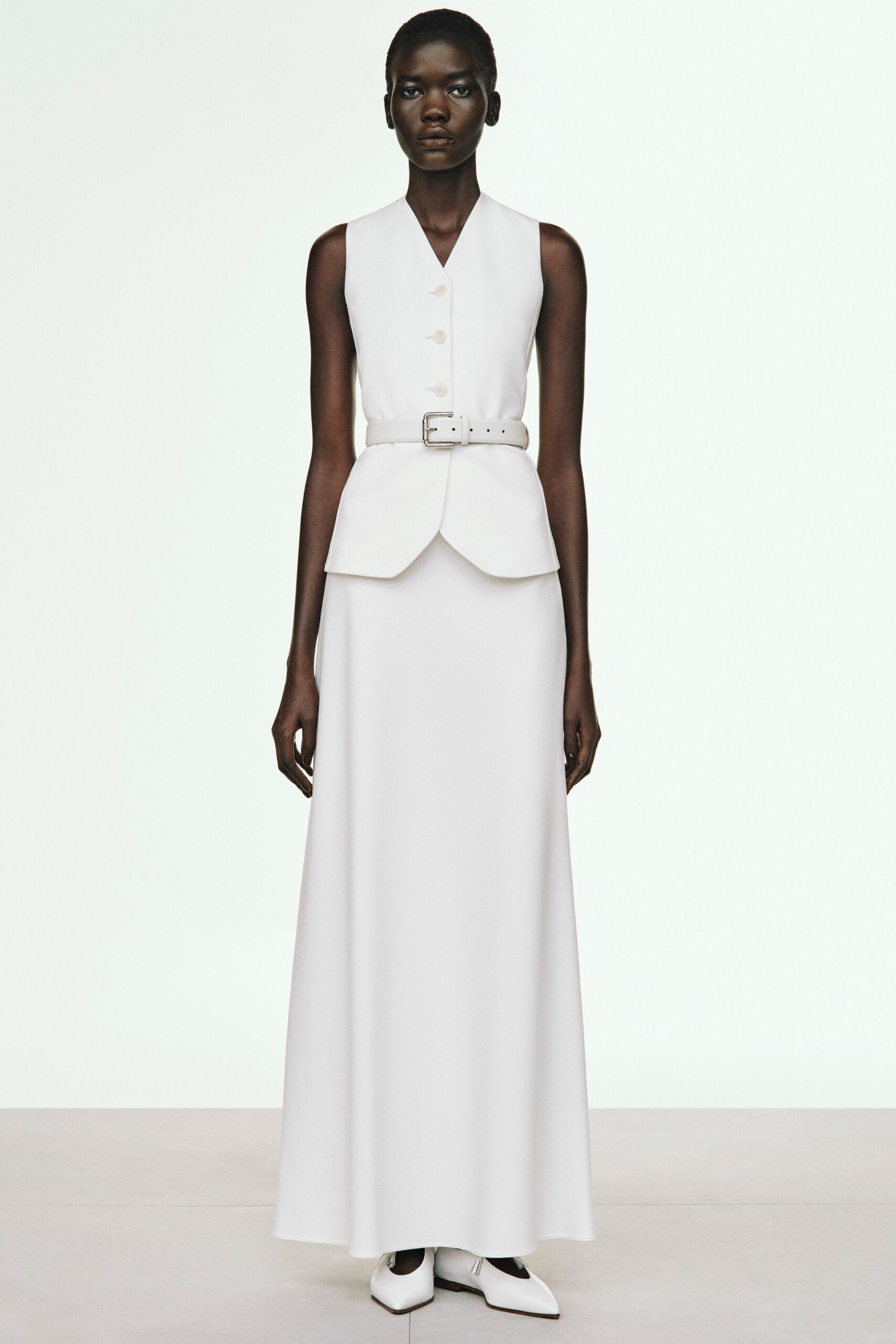 white cotton sleeveless v-neck fitted belted layered gown