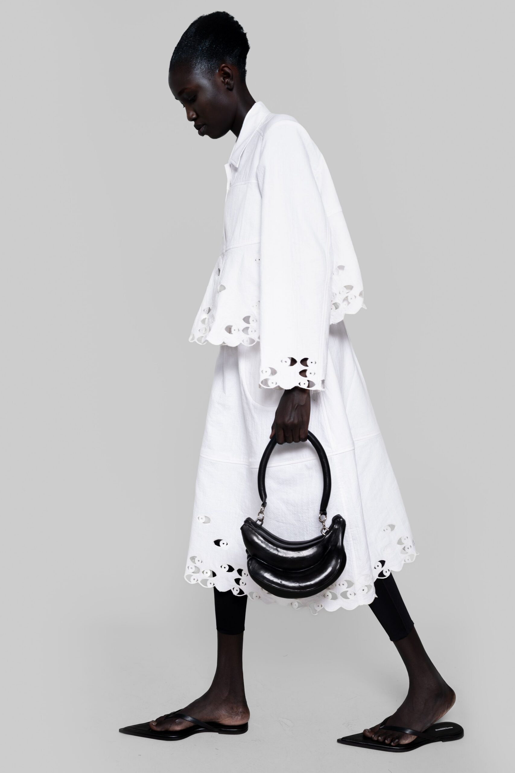 white embroidered coat with black pants