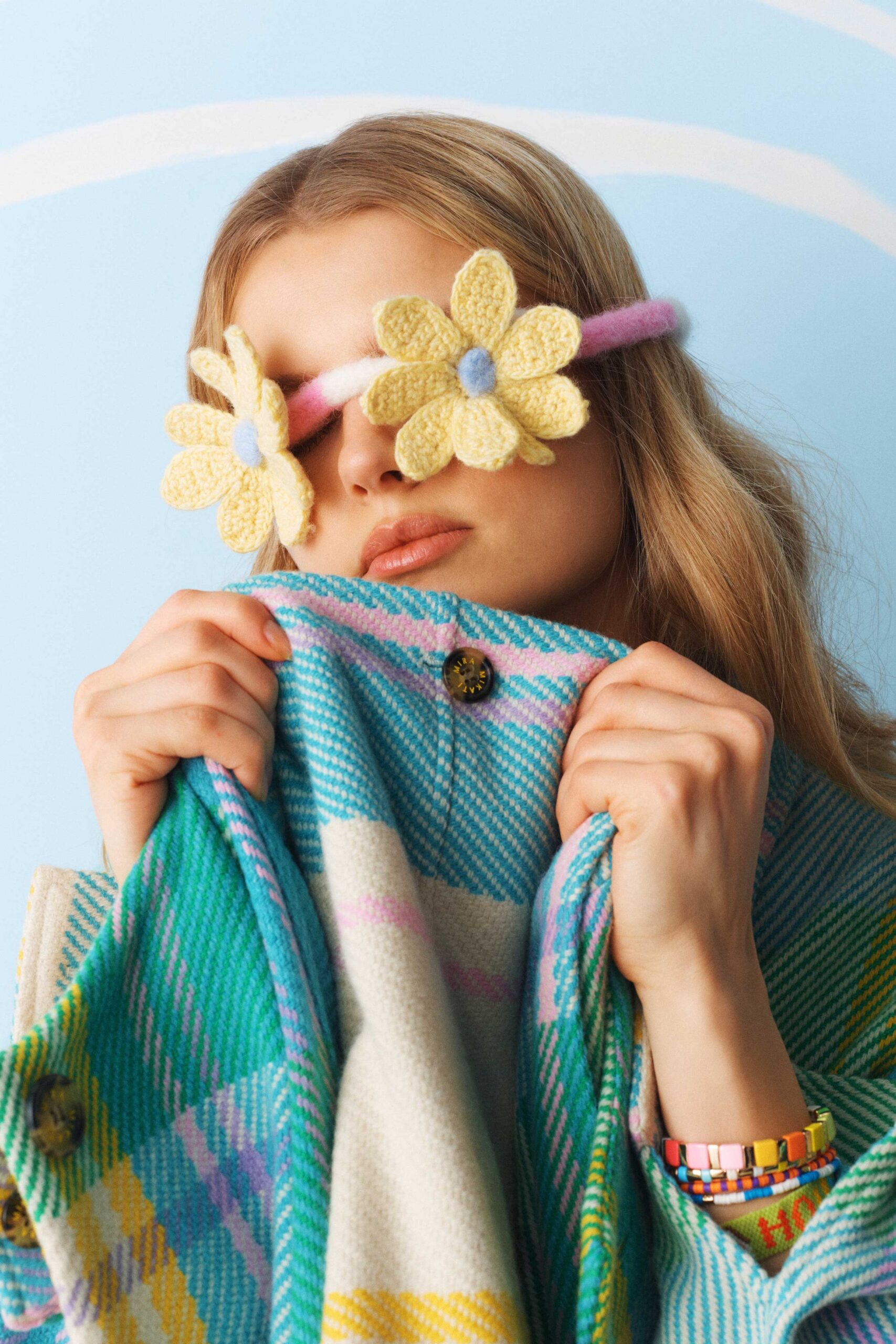 checked wool coat with floral accessory