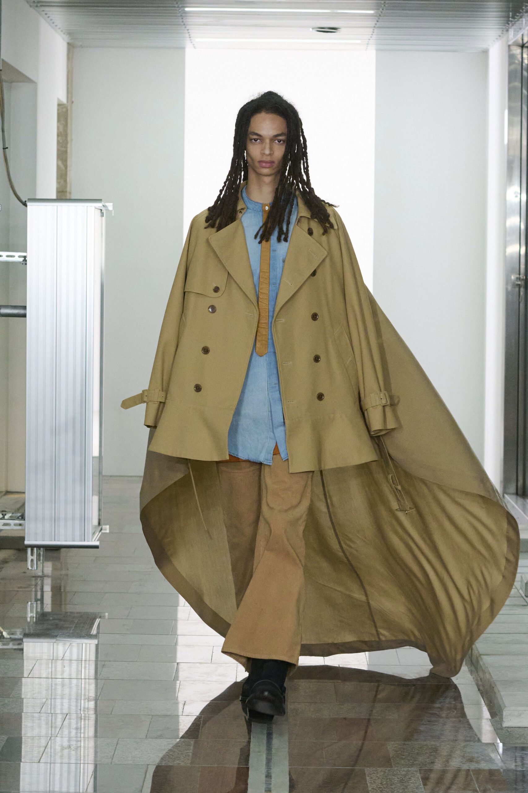 beige coat blue shirt brown pants