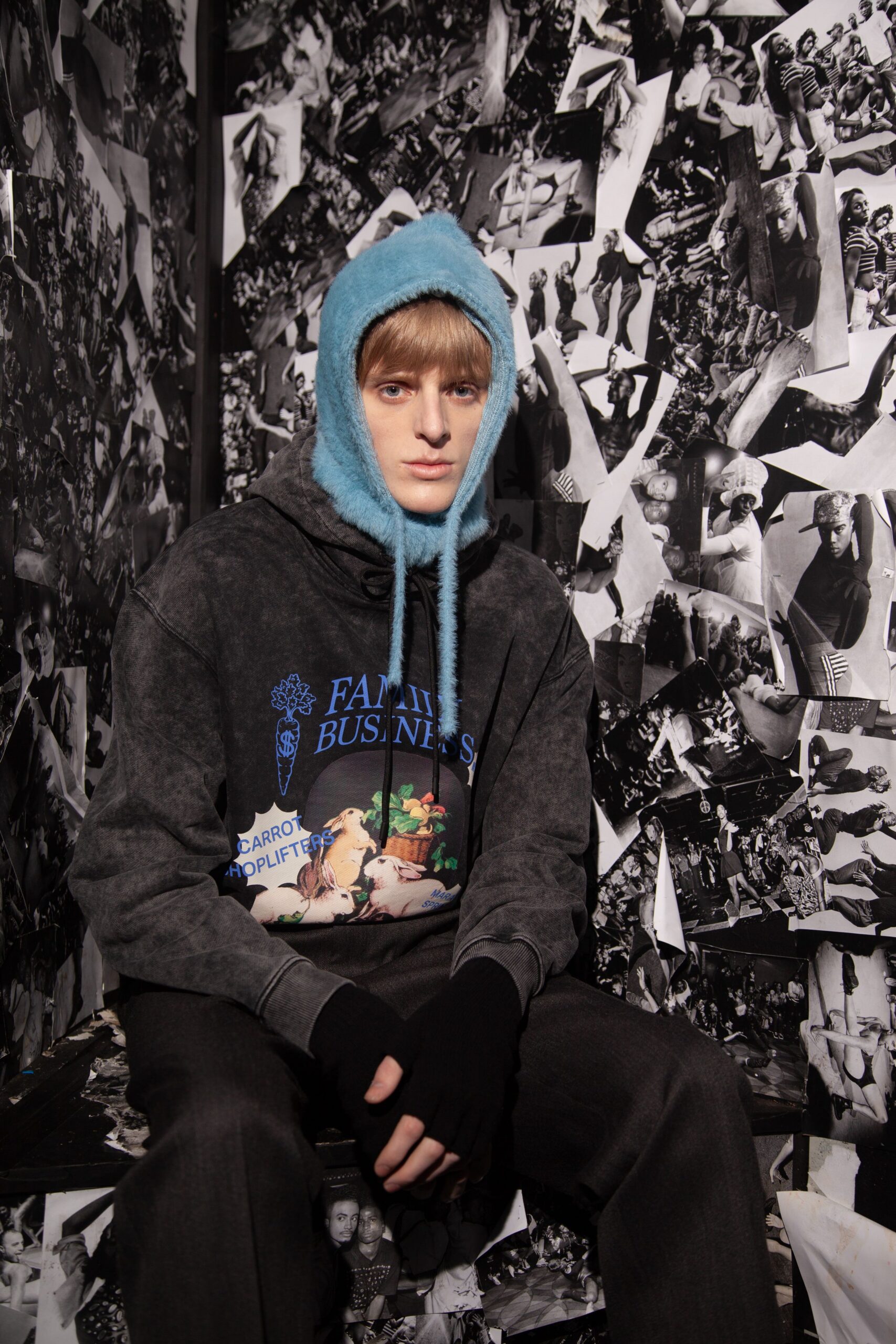 black hoodie gray pants blue hat