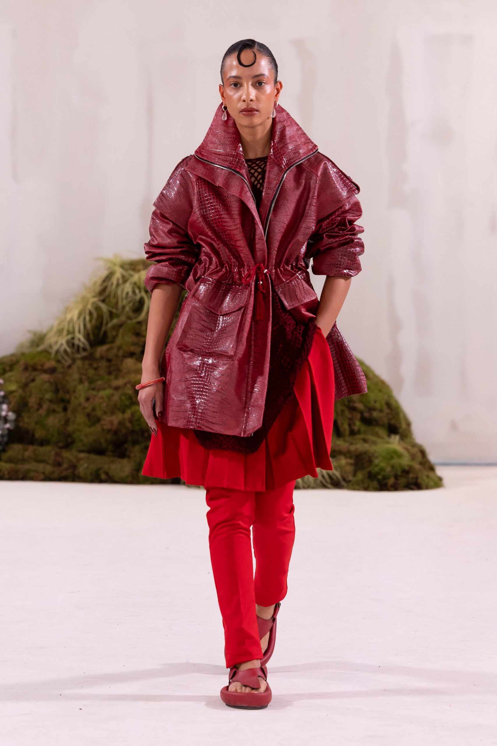 red leather coat with pleated skirt