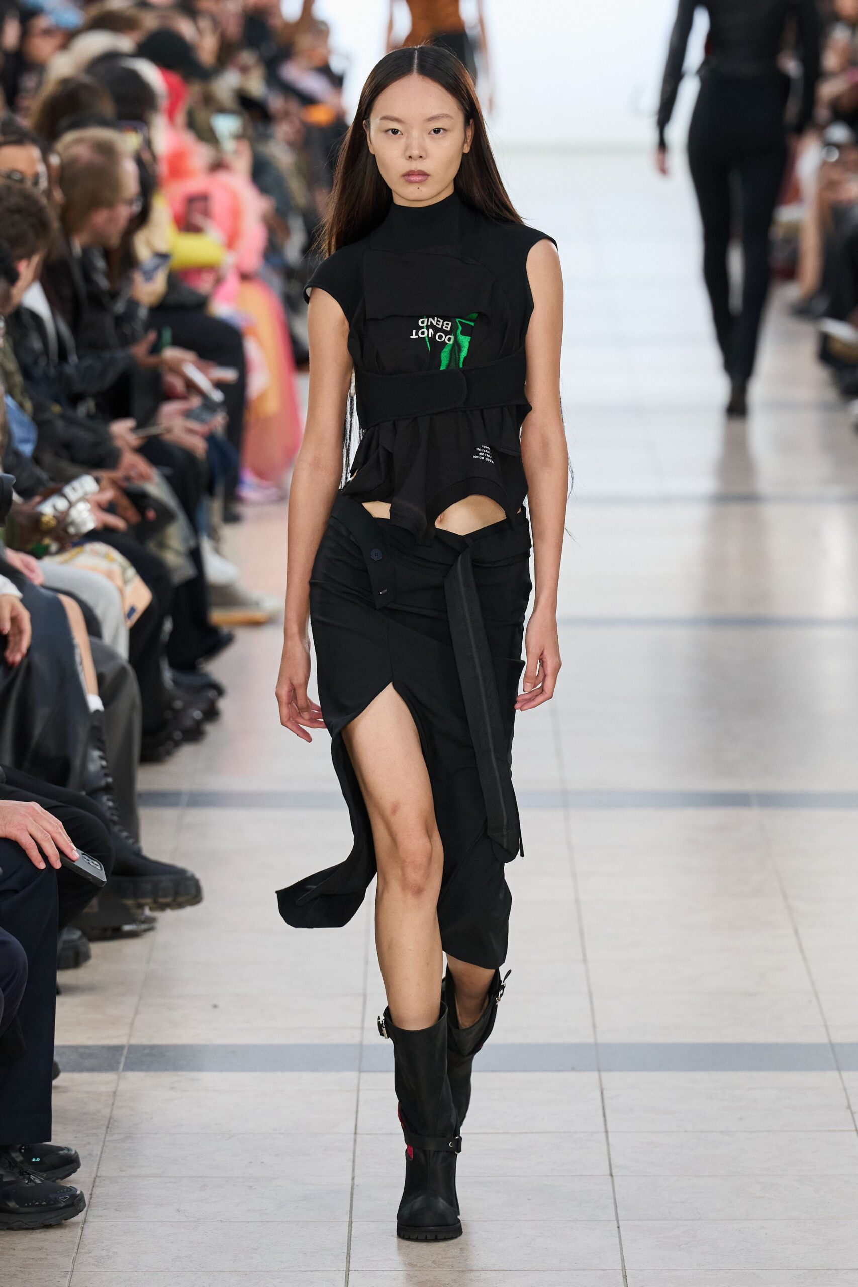 black fitted top and skirt with boots
