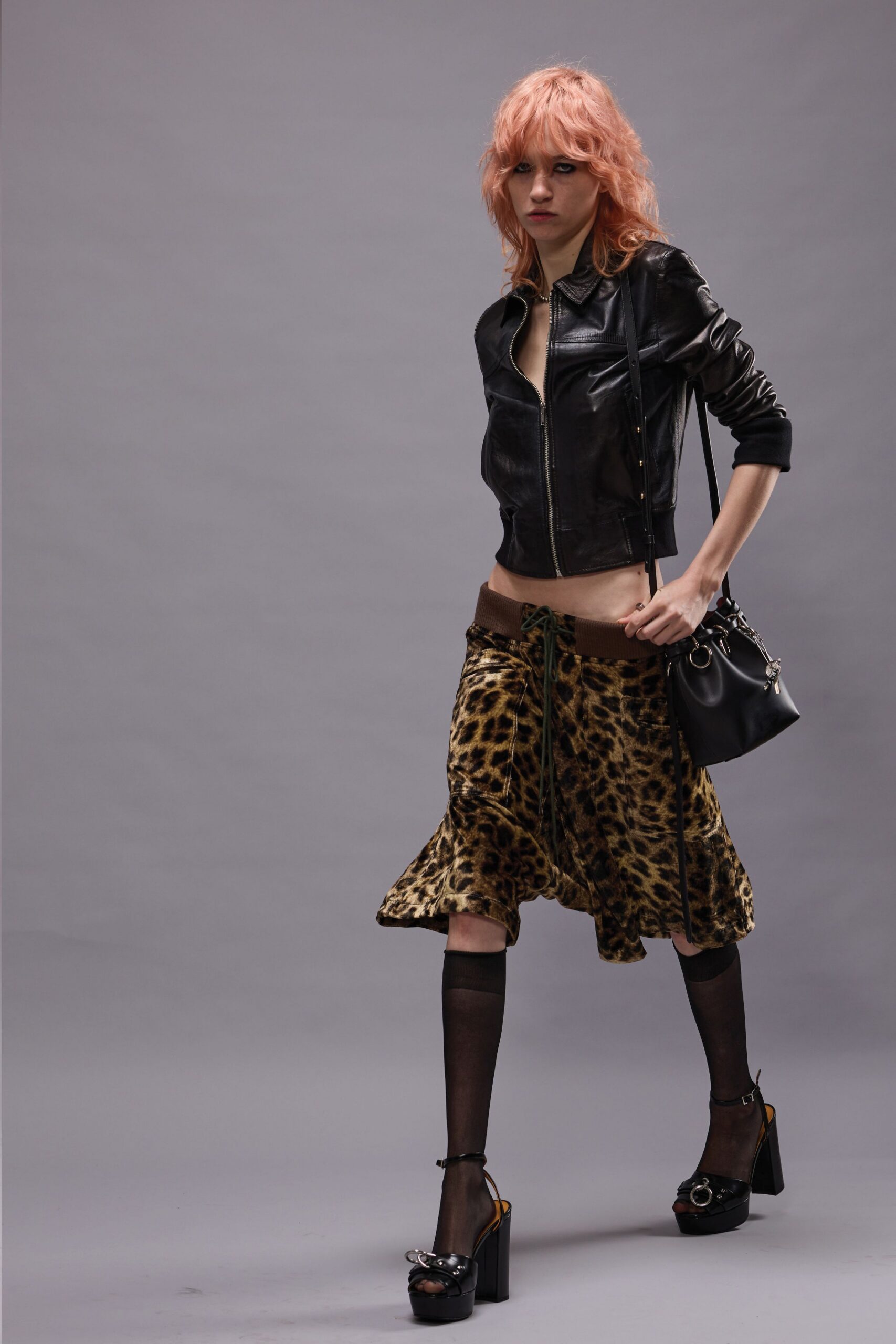 black leather jacket with animal-print skirt