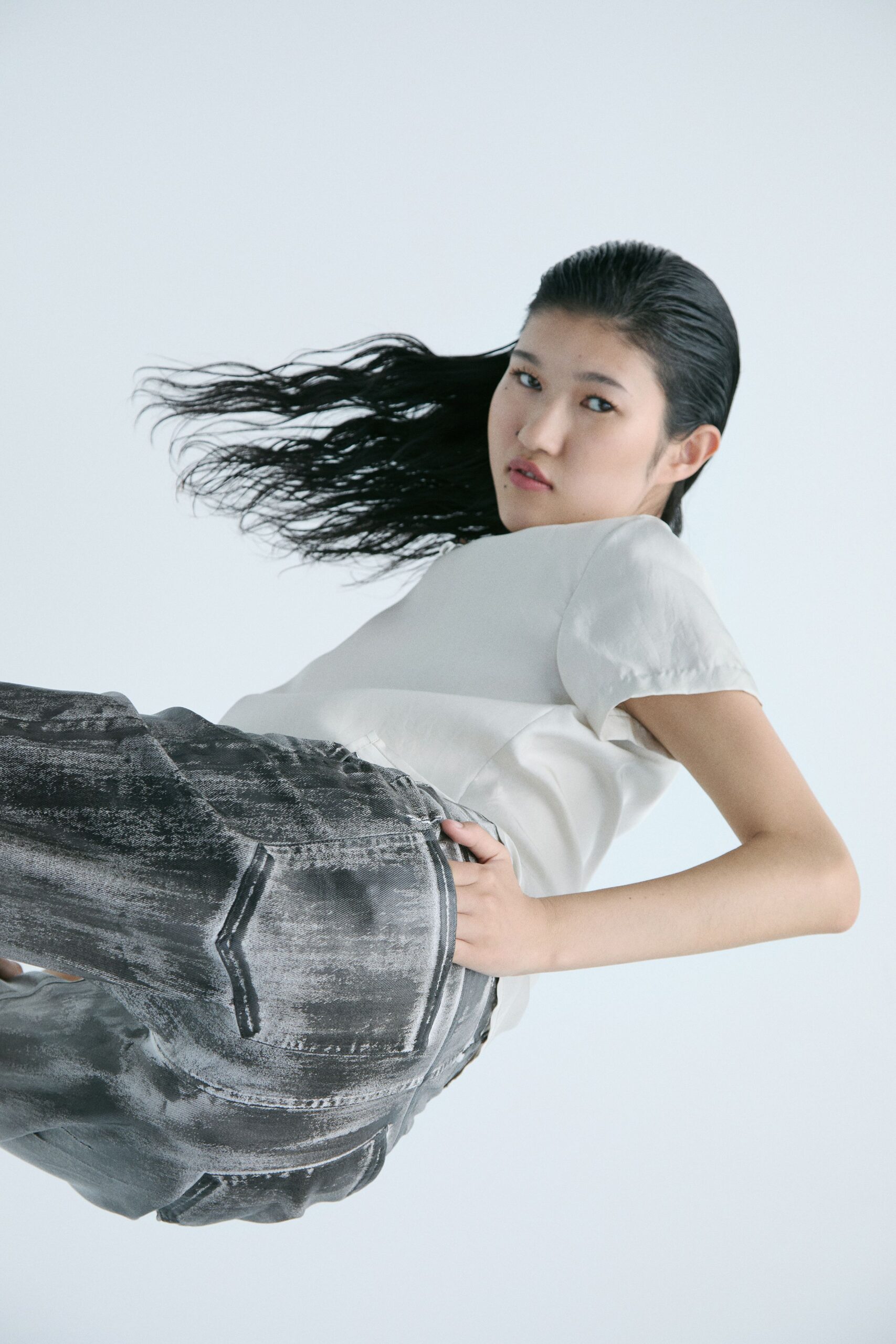 white silk top and gray denim pants