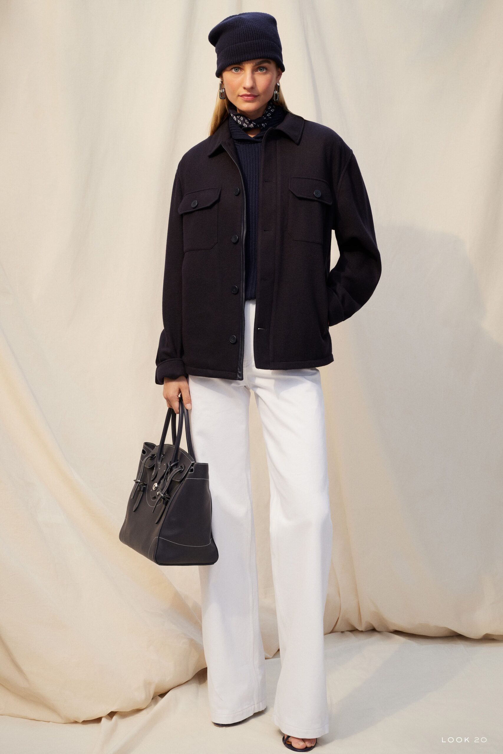 black jacket navy sweater white pants