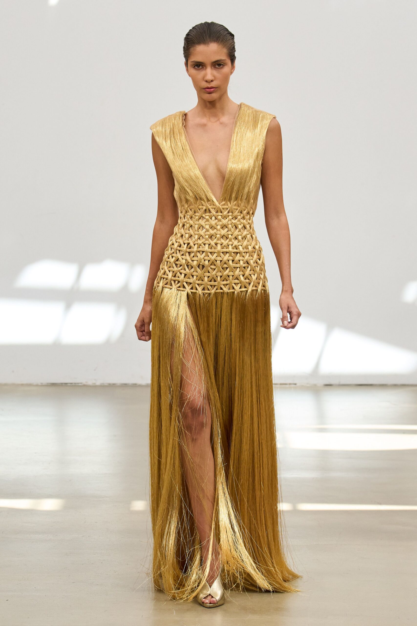 gold silk sleeveless v-neck fitted pleated flowing gown