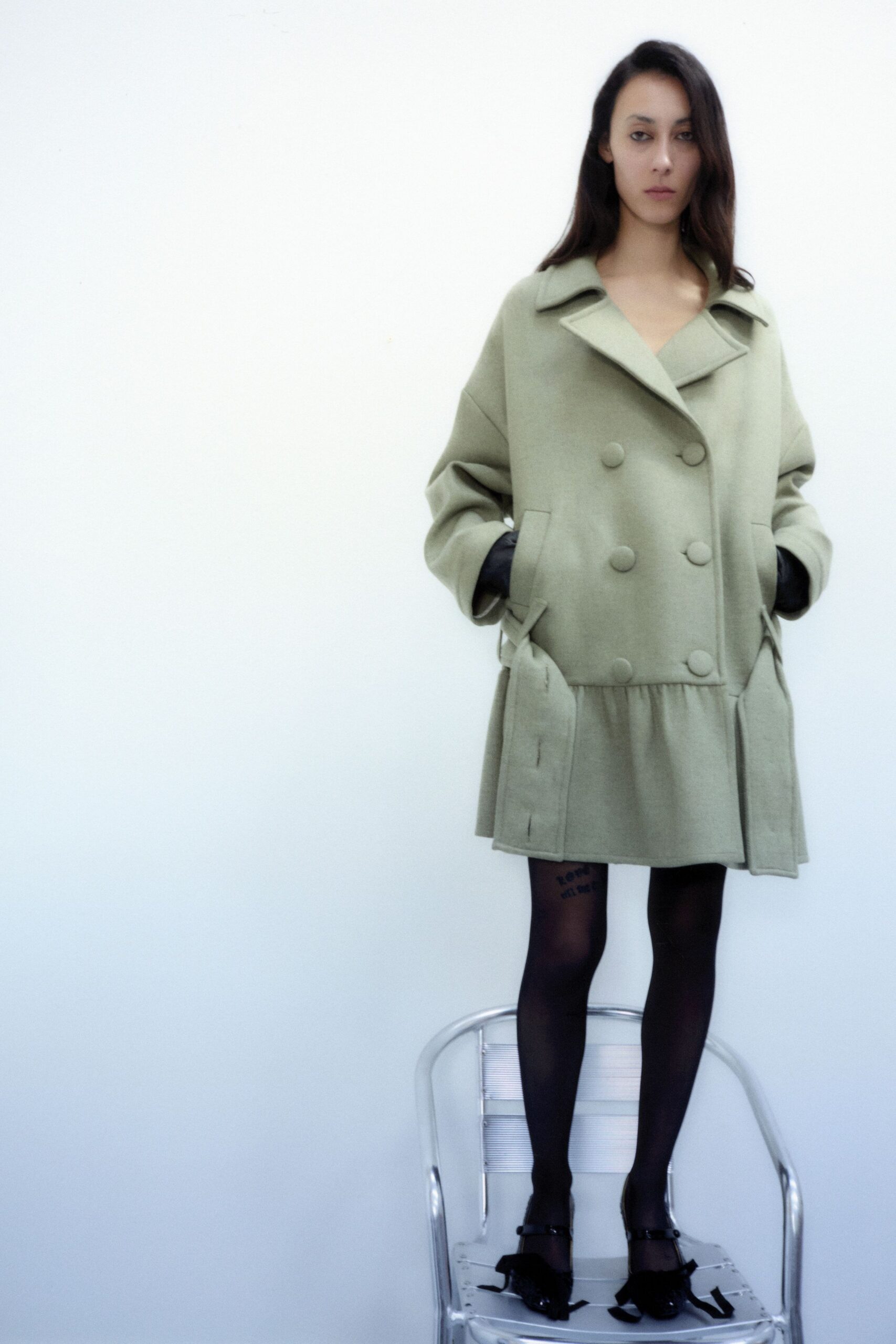 oversized green wool coat with black shoes
